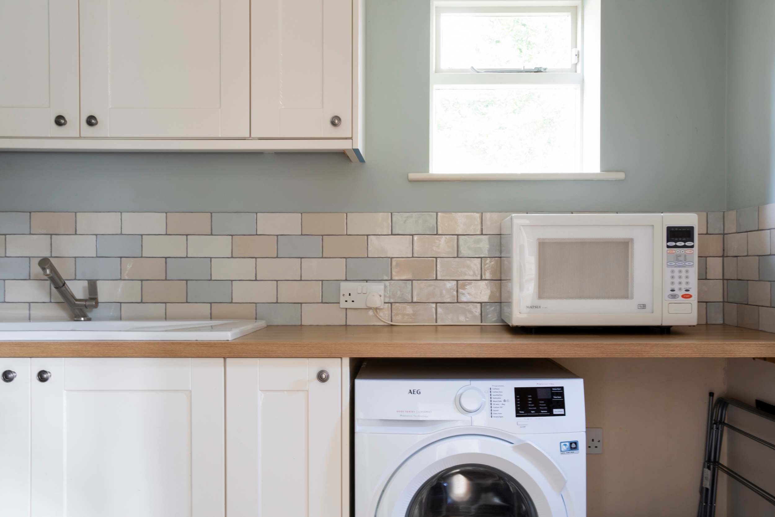 Our handy utility room with butler sink and washing machine