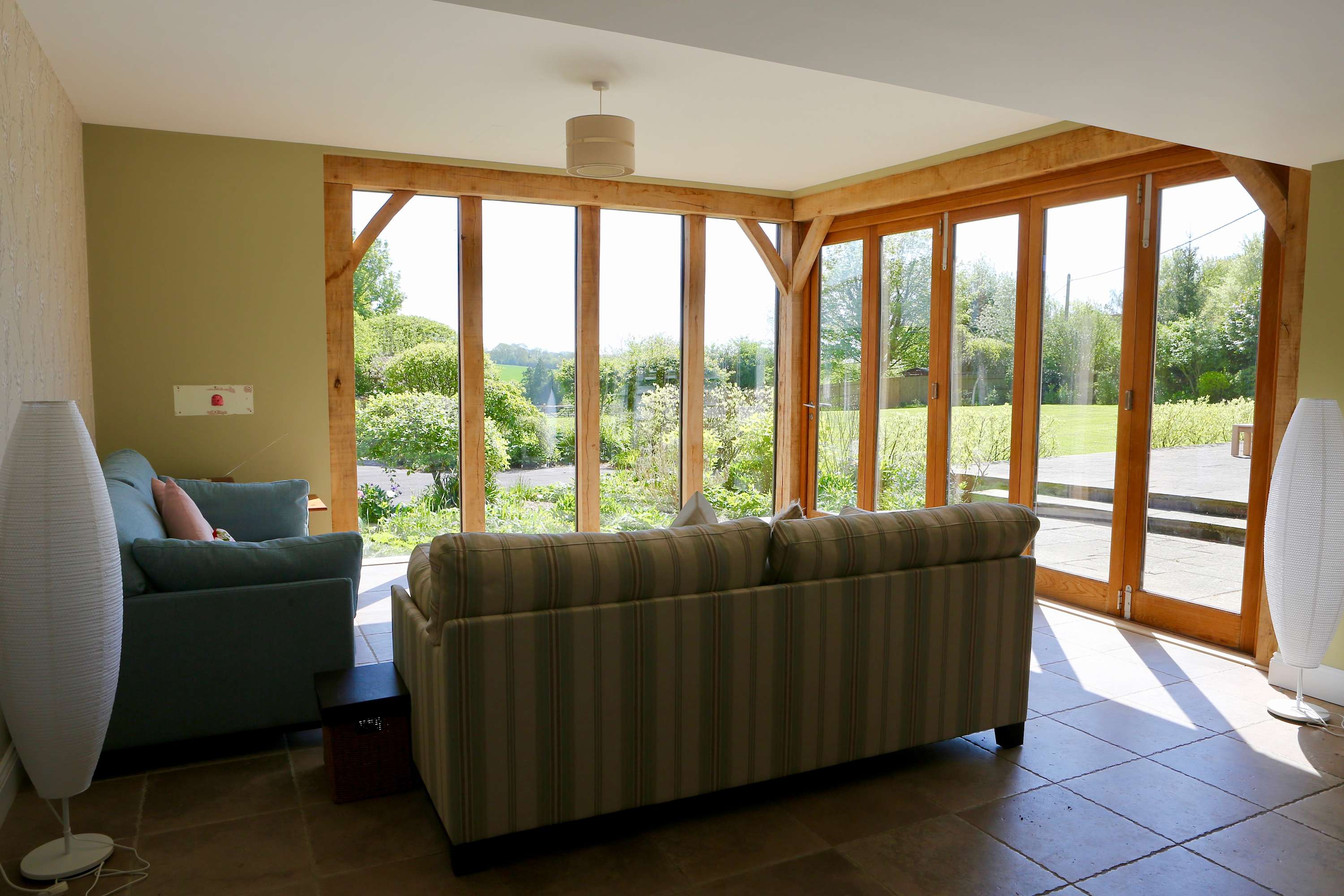 The Lounge Area in the kitchen has beautiful floor to ceiling windows and patio door that opens out to the outside dining area