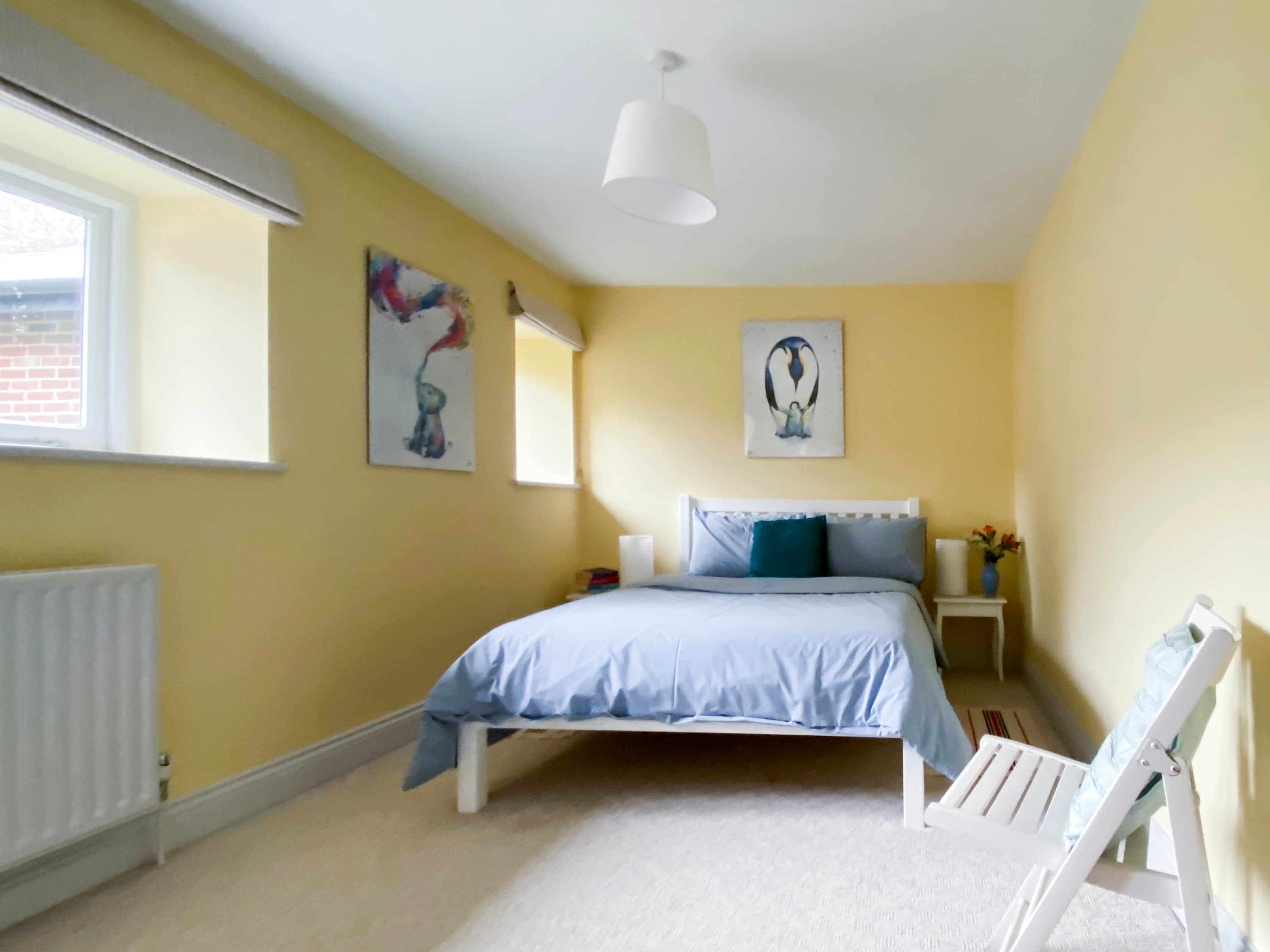Bedroom 2 is light and airy with a double bed and side tables