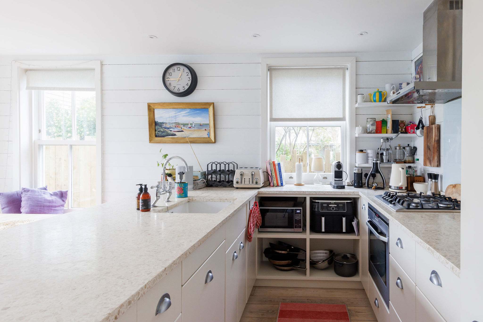 Prepare delicious meals in our fully equipped kitchen, featuring a large island and ample storage