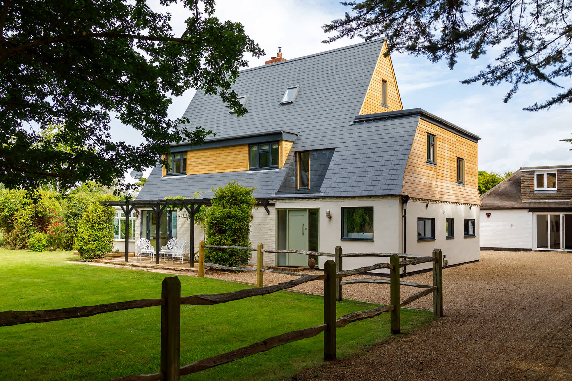 A long drive way leads to the home, with a large front lawn for croquet and a tennis court.