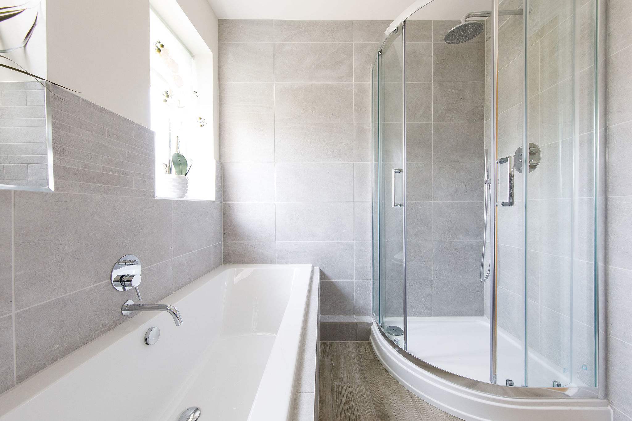 The modern family bathroom has a bath, separate shower, WC and sink.