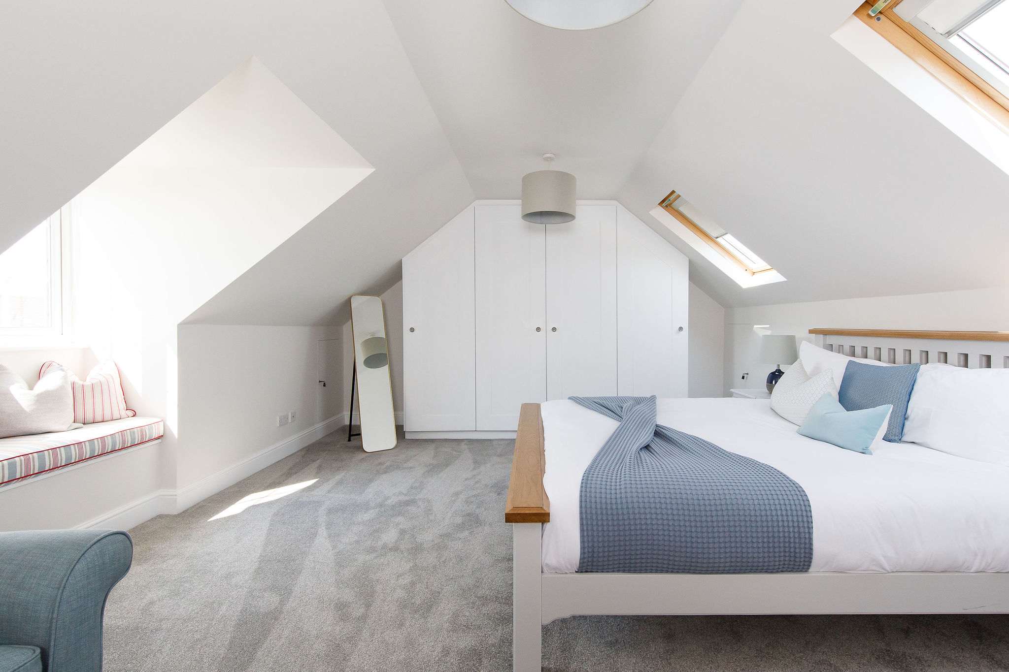 The second upstairs super king is light and bright, with soft blue furnishing.