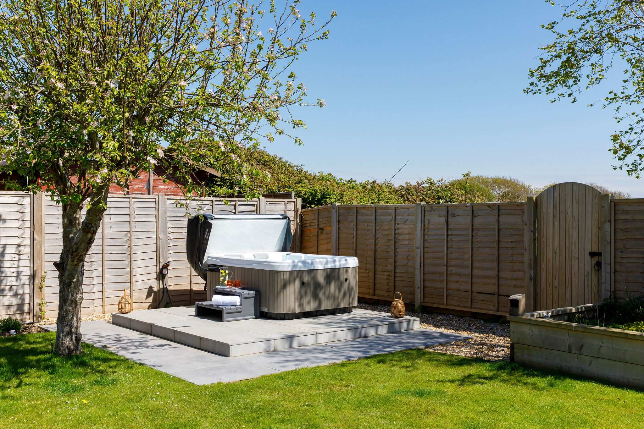 Enjoy a soak in the private hot tub, surrounded by a peaceful and beautifully maintained garden.