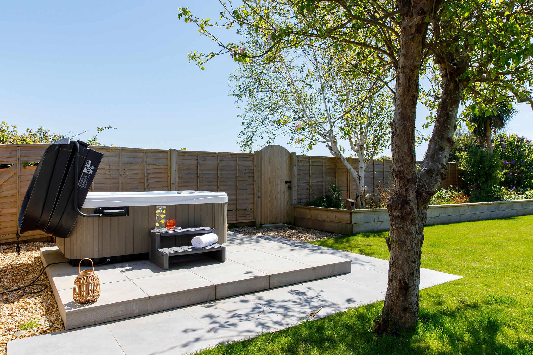 A spacious garden perfect for outdoor activities and relaxation, featuring a hot tub for unwinding.