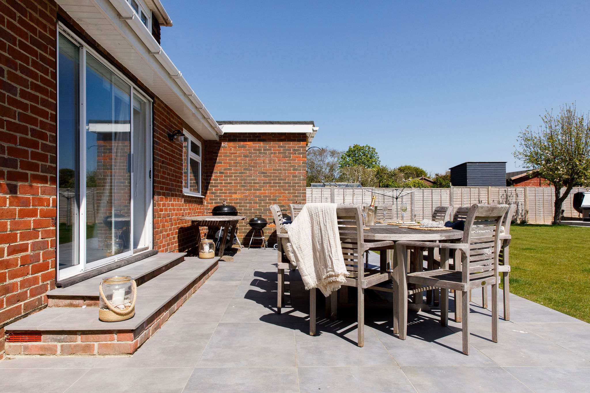 Enjoy meals or drinks on the comfortable patio, overlooking the large garden.