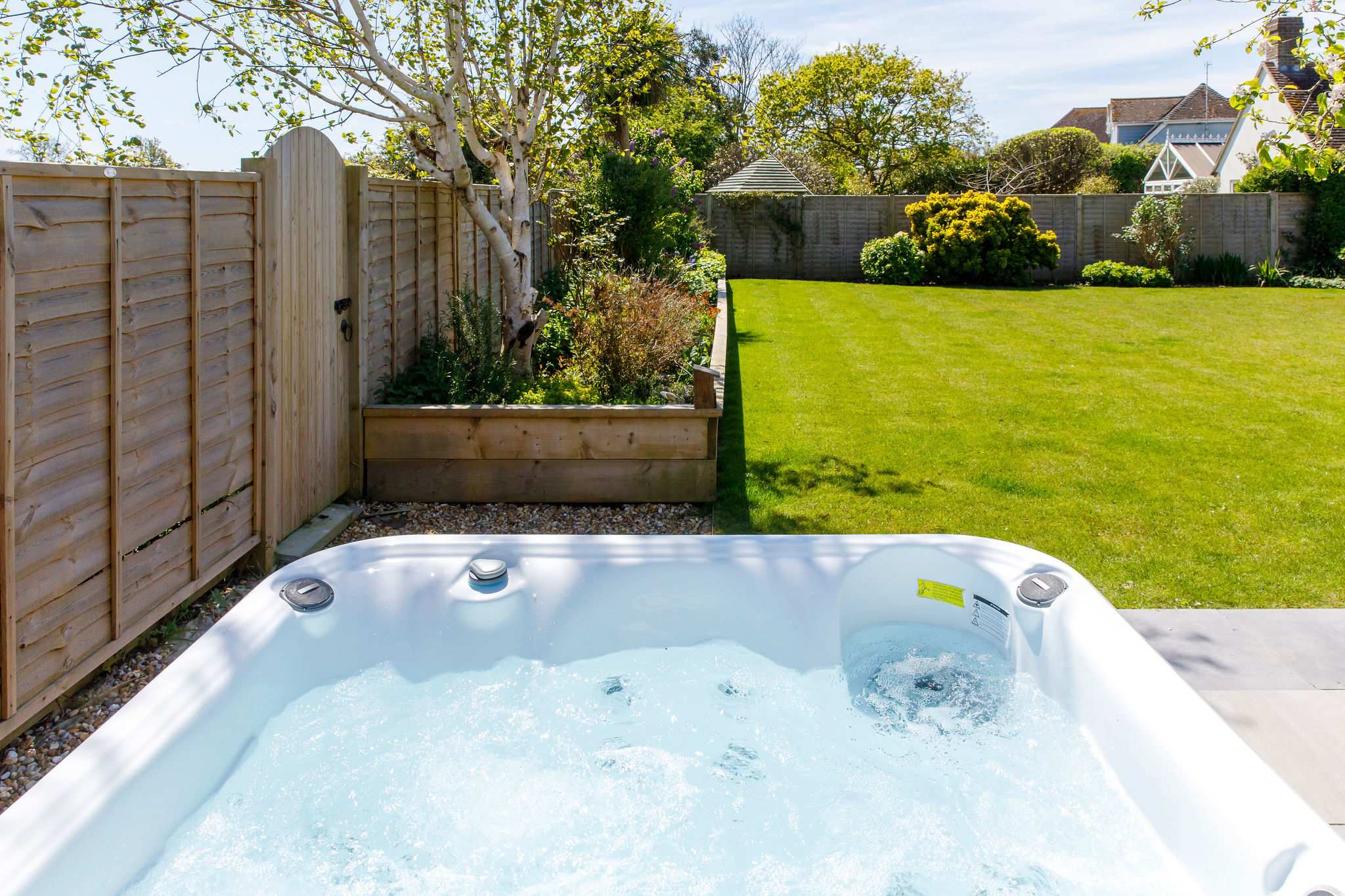 Expansive lawn area ideal for family games, picnics, or simply lounging under the sun.