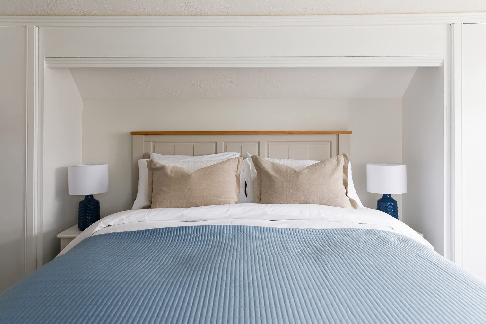 The first king room is light and bright, with soft blue furnishing.