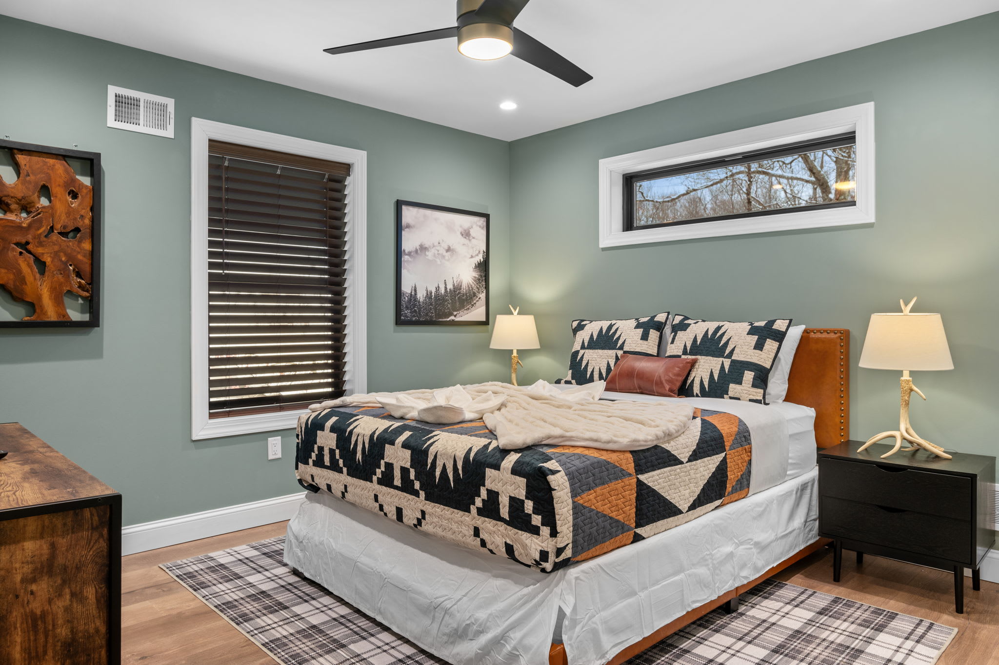 A modern retreat with earthy hues, soft lighting, and stylish bedding. A peaceful escape for a great night’s sleep.