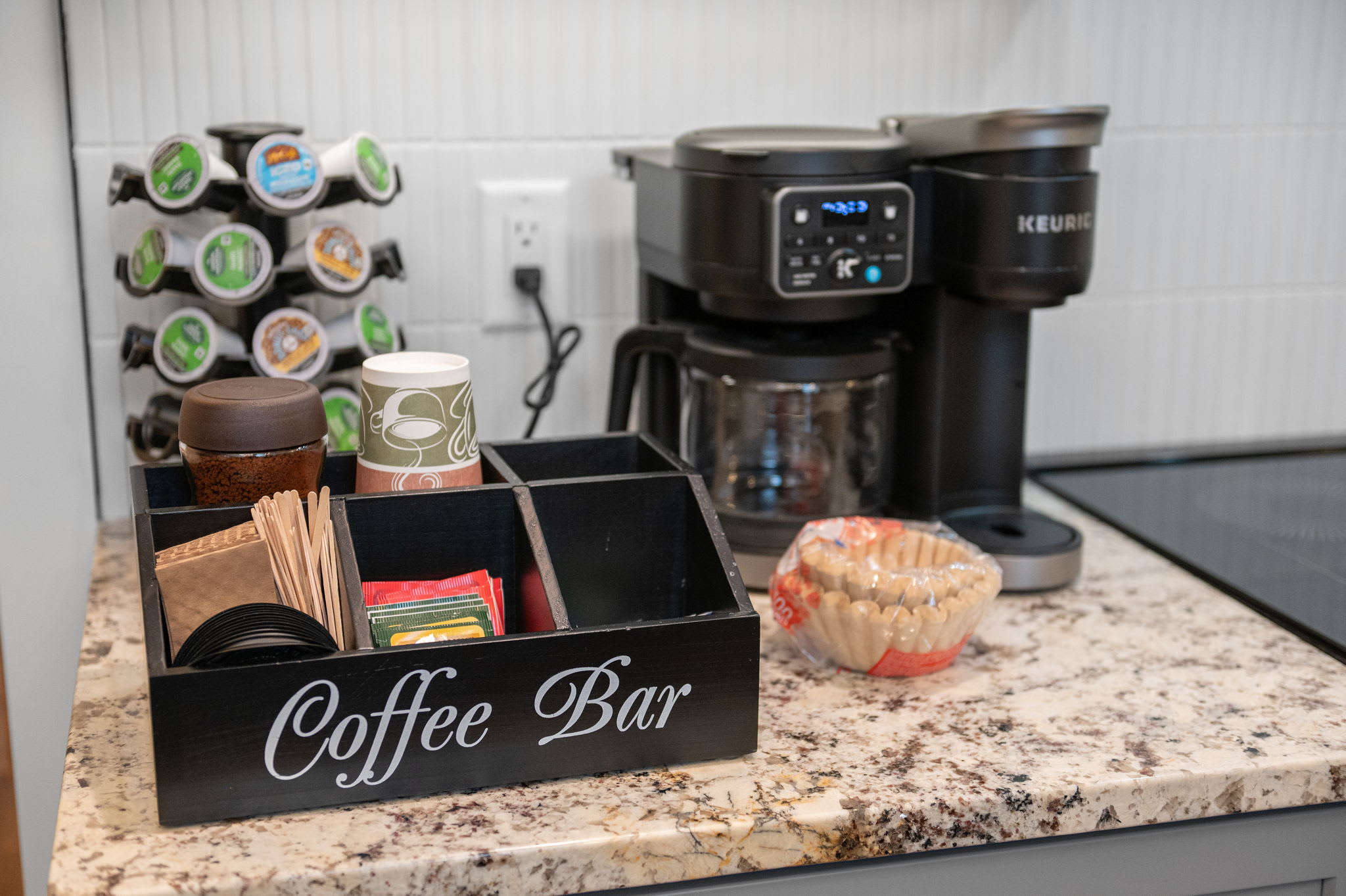 A dedicated coffee bar awaits, stocked with pods, filters, and both drip and single-serve coffee makers to suit any morning routine.