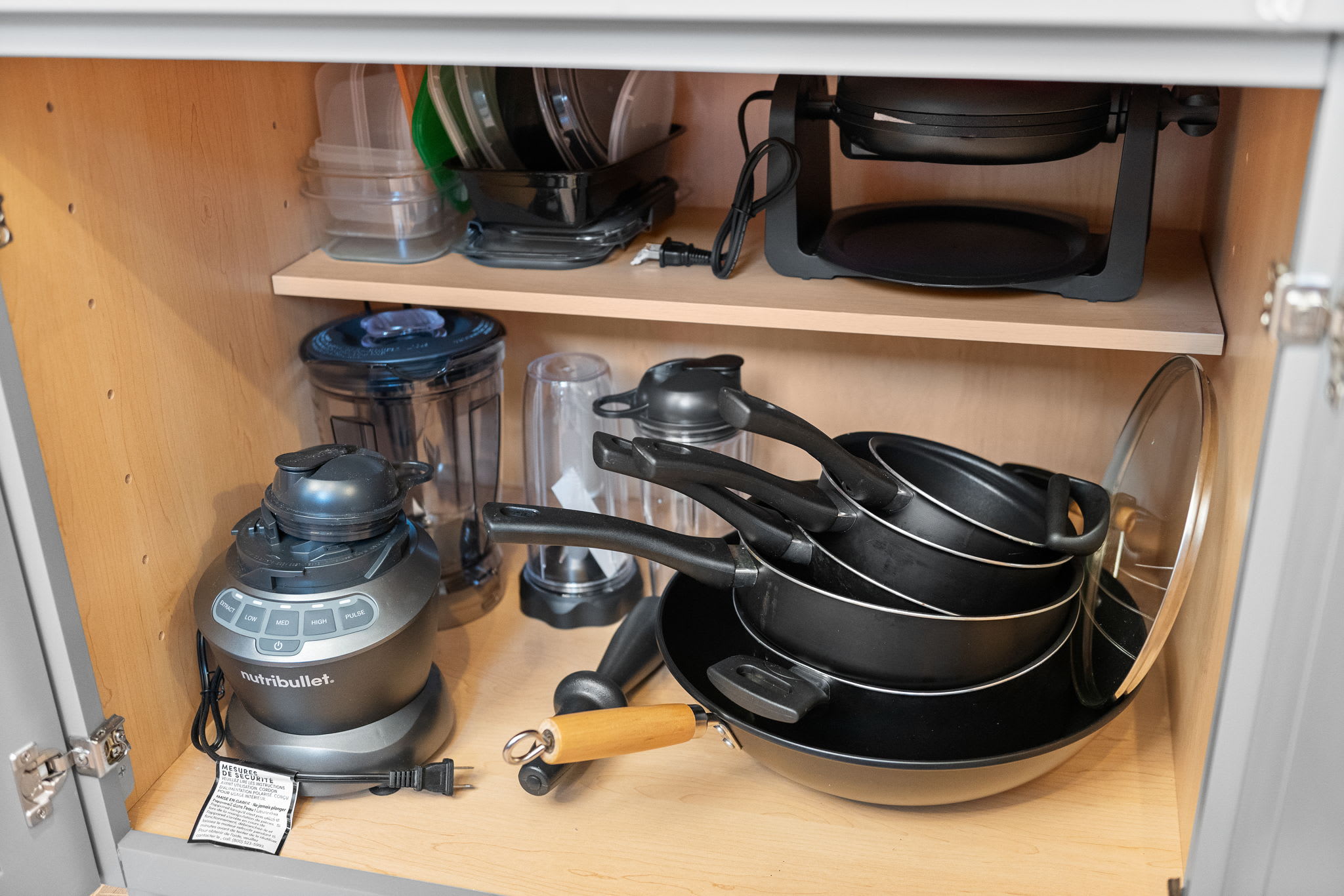 Inside the lower cabinets, you’ll find a full set of pots, pans, and small appliances, everything you need for homemade meals.