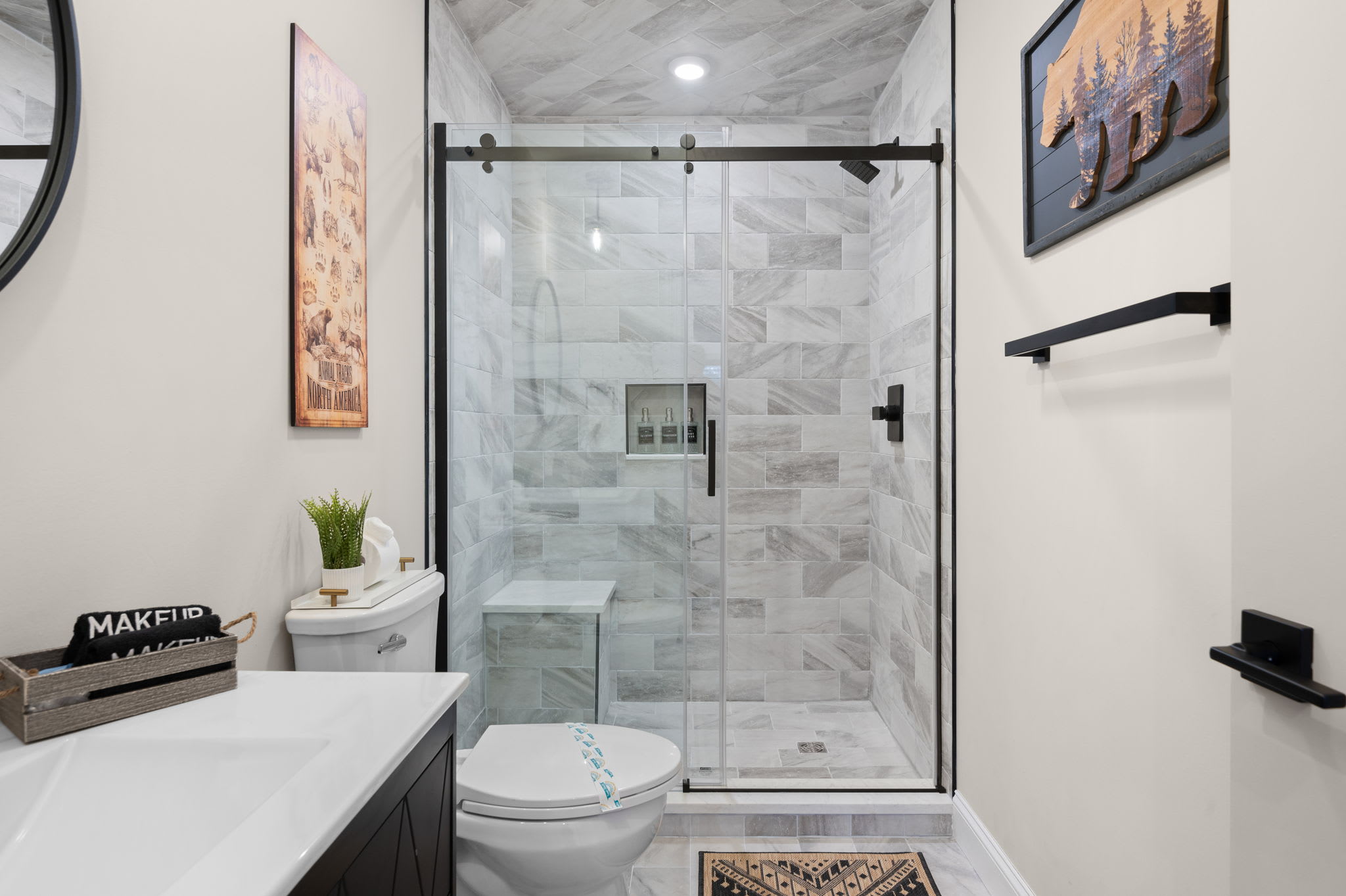 A pristine walk-in shower with elegant stone tiling, built-in shelving, and a spa-like ambiance, your personal oasis during your stay.