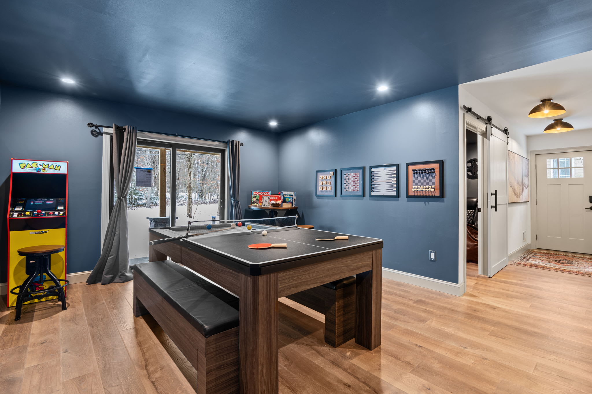 This inviting game room offers plenty of space for friendly competition or a relaxing evening. With direct access to the outdoors, it’s the perfect spot for both excitement and unwinding.