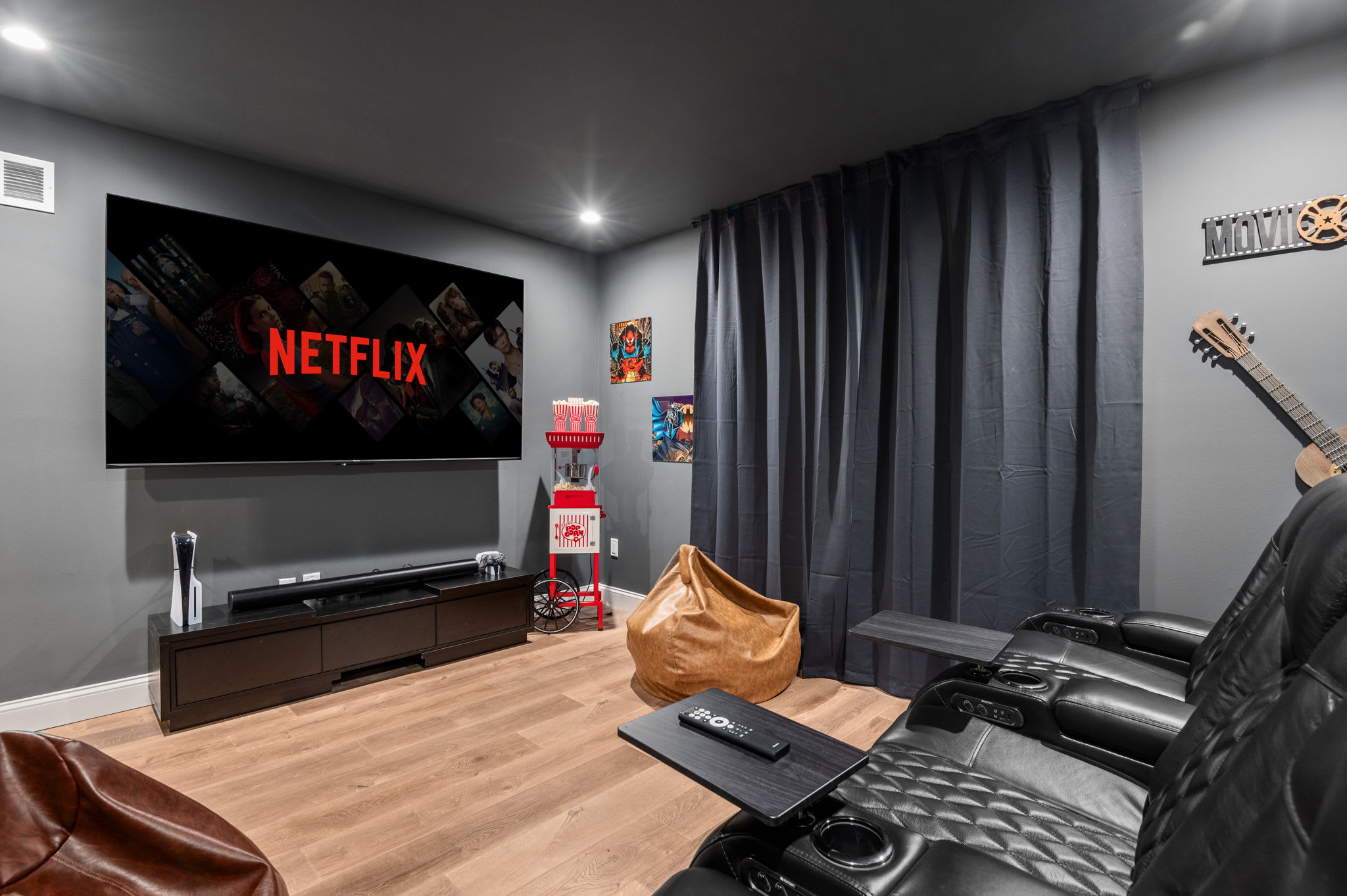 A large-screen setup with surround sound, comfy seating, and a popcorn station, because every stay deserves a little Hollywood magic.