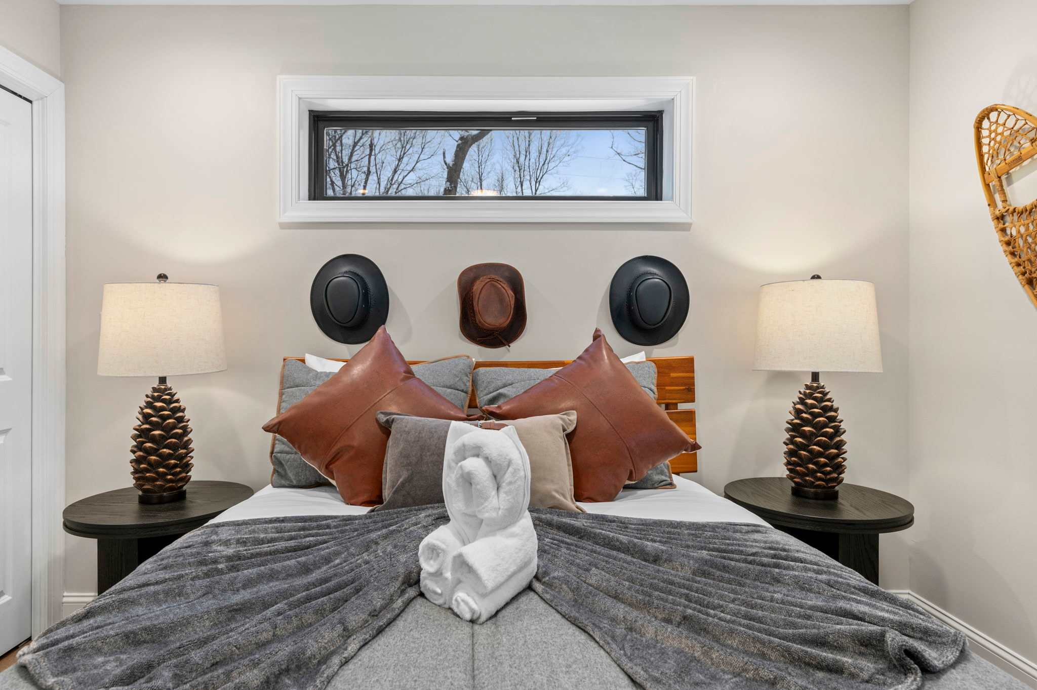 Rustic charm meets boutique comfort in this inviting bedroom. Earthy tones, soft lighting, and unique decor create a warm and relaxing ambiance.