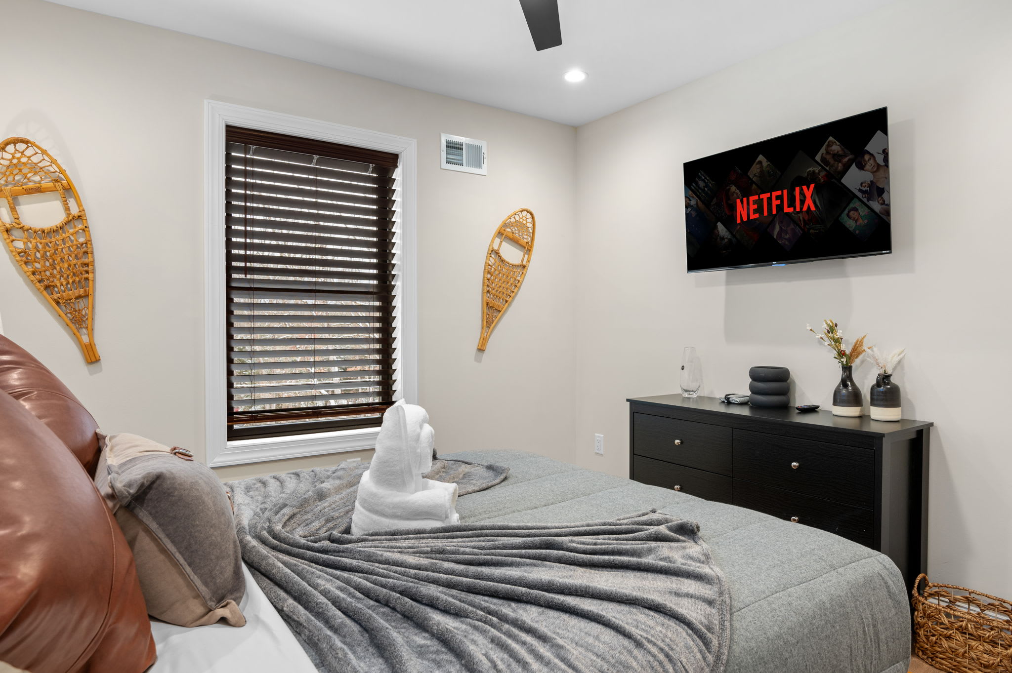 Enjoy movie nights from the comfort of your bed with a mounted TV and cozy surroundings.