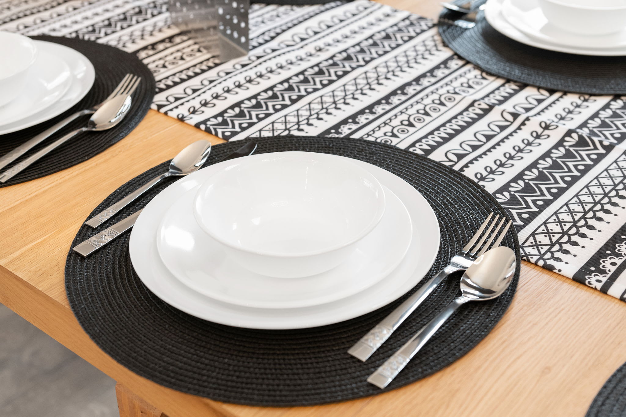 Up close, the table settings feature modern black accents and fun patterns, adding a stylish touch to your dining experience.