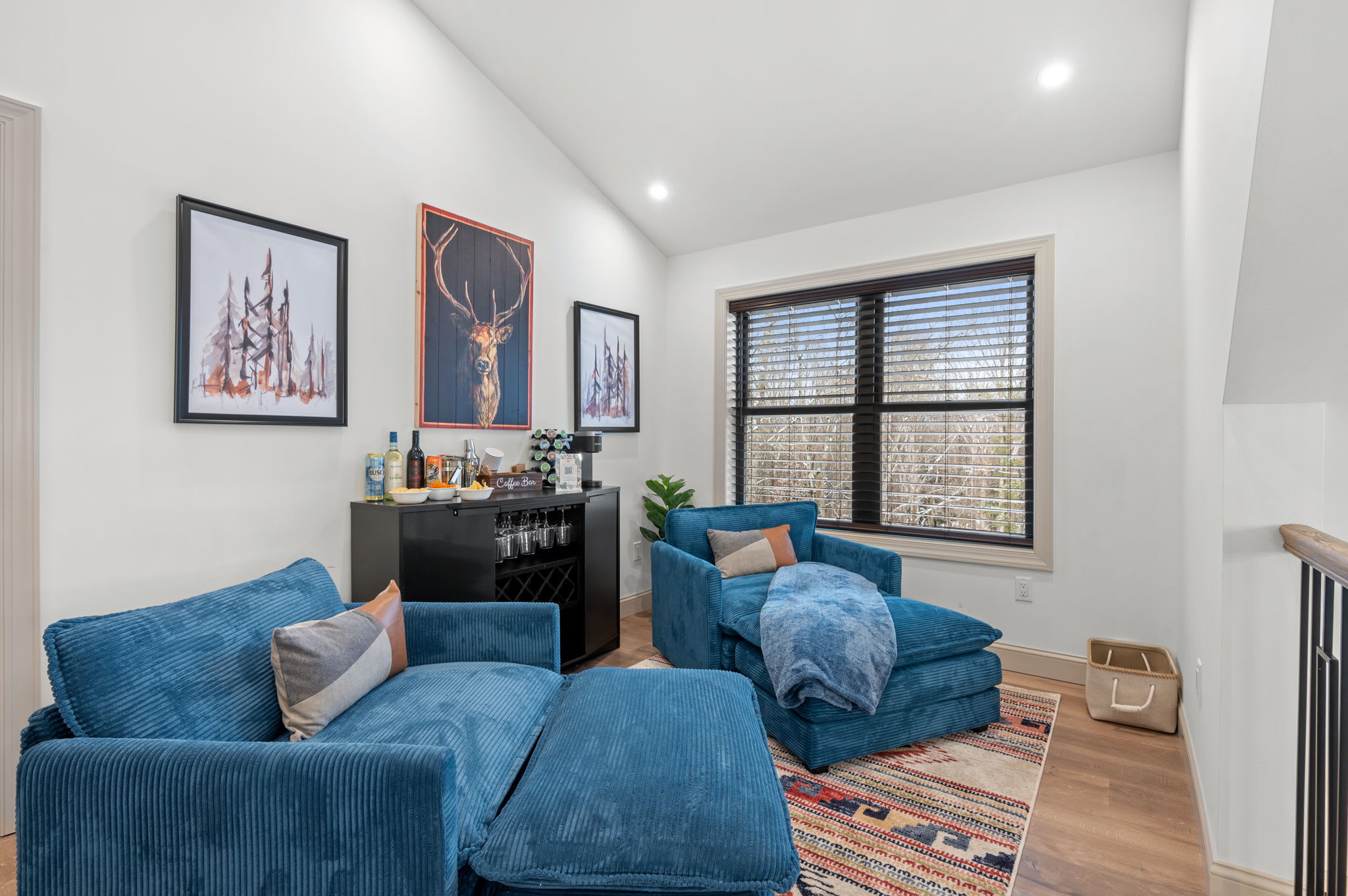 Tucked away upstairs, a cozy lounge with plush chairs and a mini bar is perfect for a quiet reading nook or a late-night nightcap.