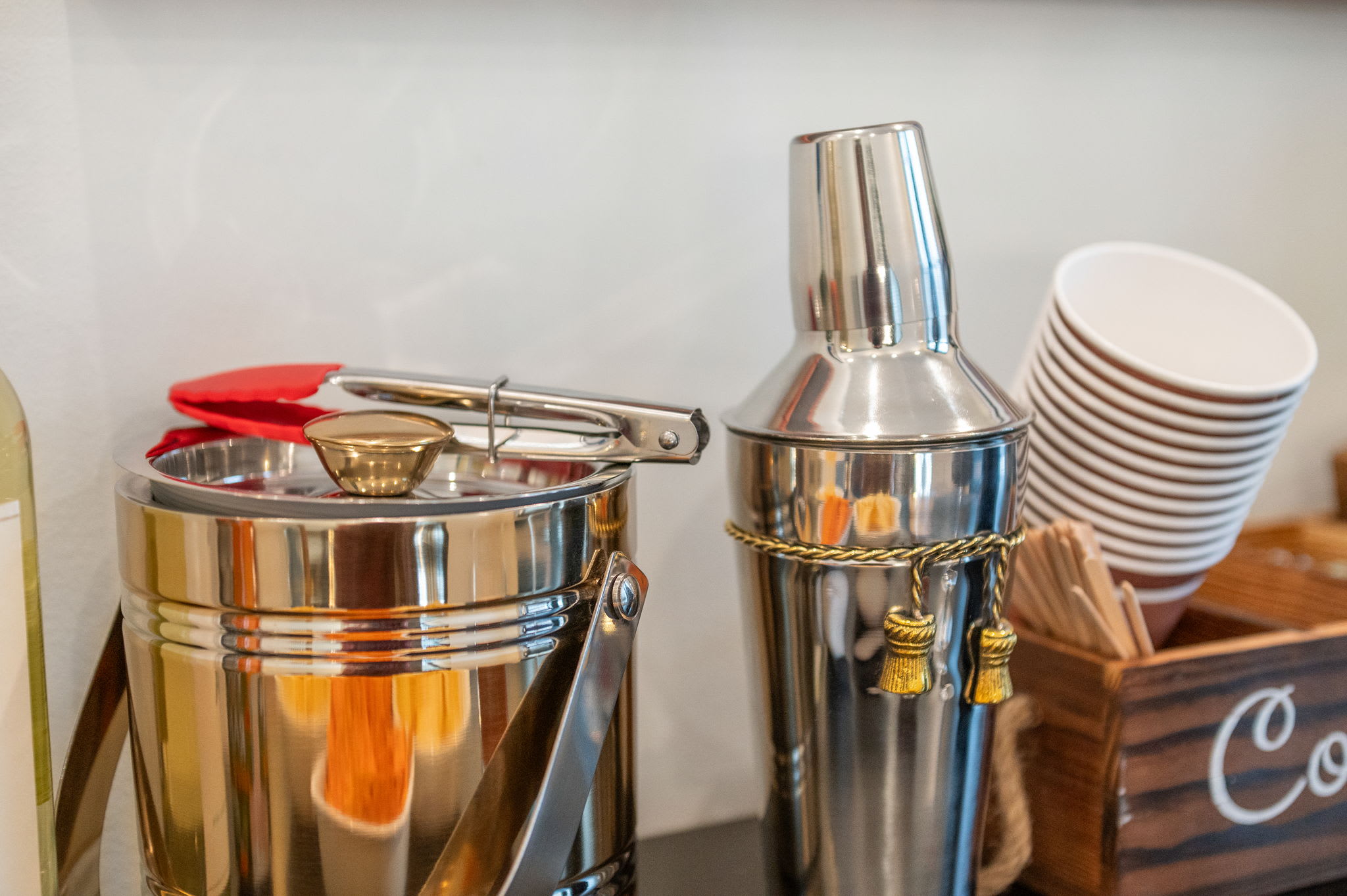 A close-up of the bar’s essentials, cocktail shaker, ice bucket, and cups, ready to help you craft your favorite beverages.