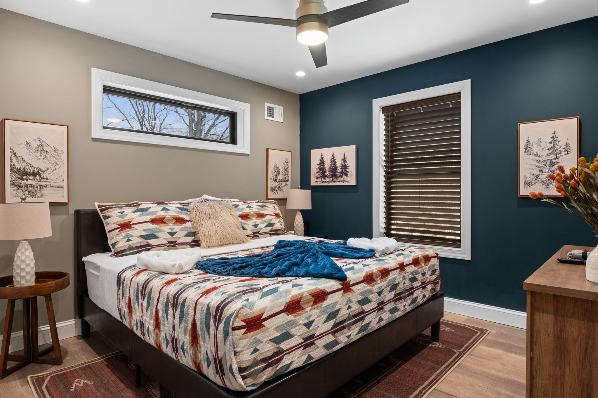 Southwestern-inspired bedding and a rich accent wall create a warm, inviting space for a restful night’s sleep.