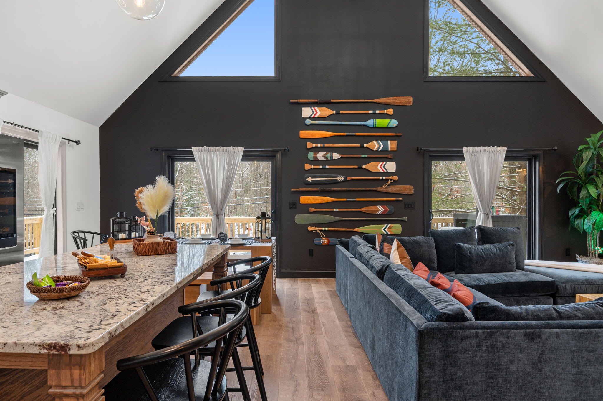 Large windows flood the open-plan design with natural light, highlighting the comfortable seating and playful décor that make entertaining a breeze.