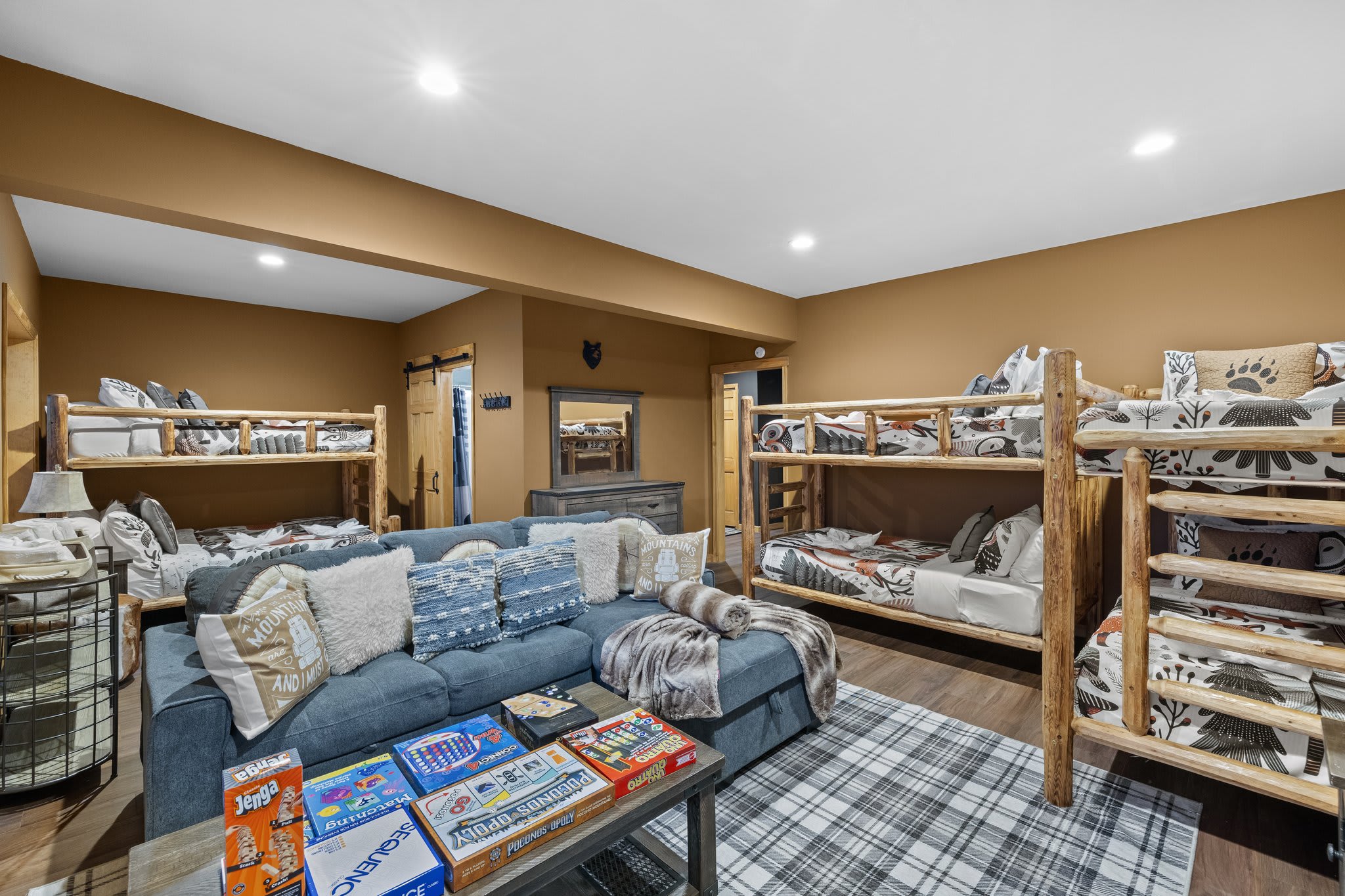 Board games, plush seating, and stacked bunks this room was built for good times and shared laughs.