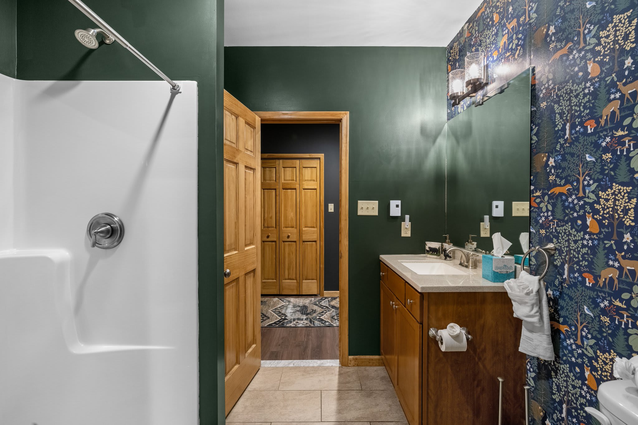 Fresh, functional, and full of charm this bathroom’s got you covered with double sinks and cabin-chic style.