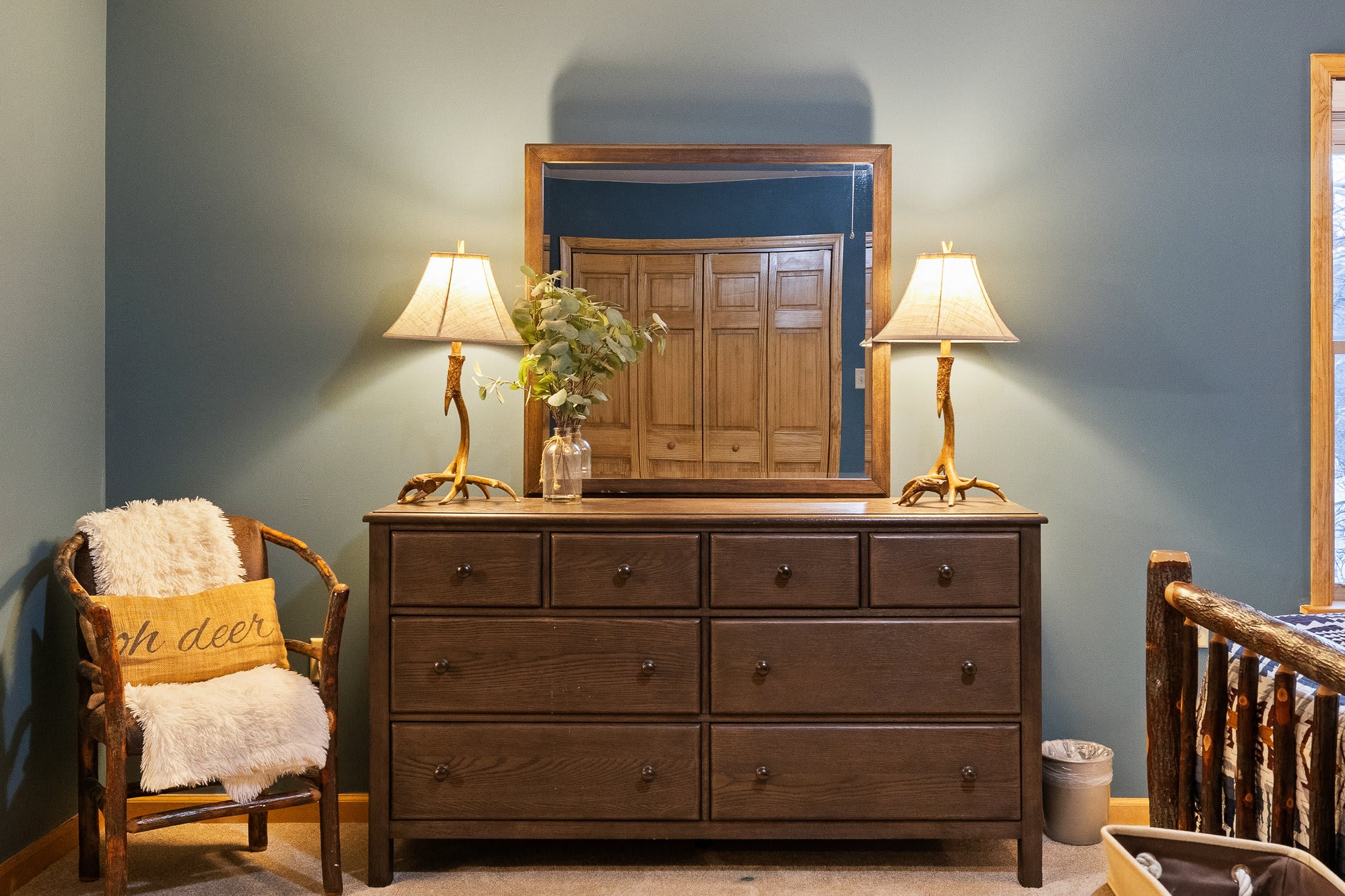 The bedroom wraps you in comfort with rich wood textures, cozy layers, and just the right mix of rustic and refined.