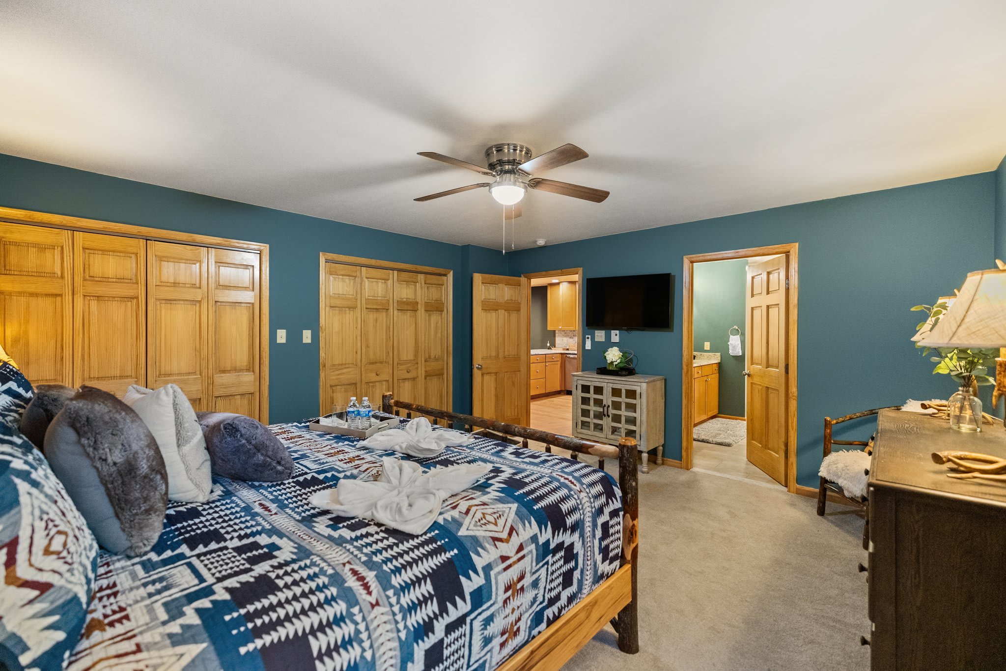 Soft blue walls, natural wood, and curated details make this space a true retreat after a day of lakeside adventures.
