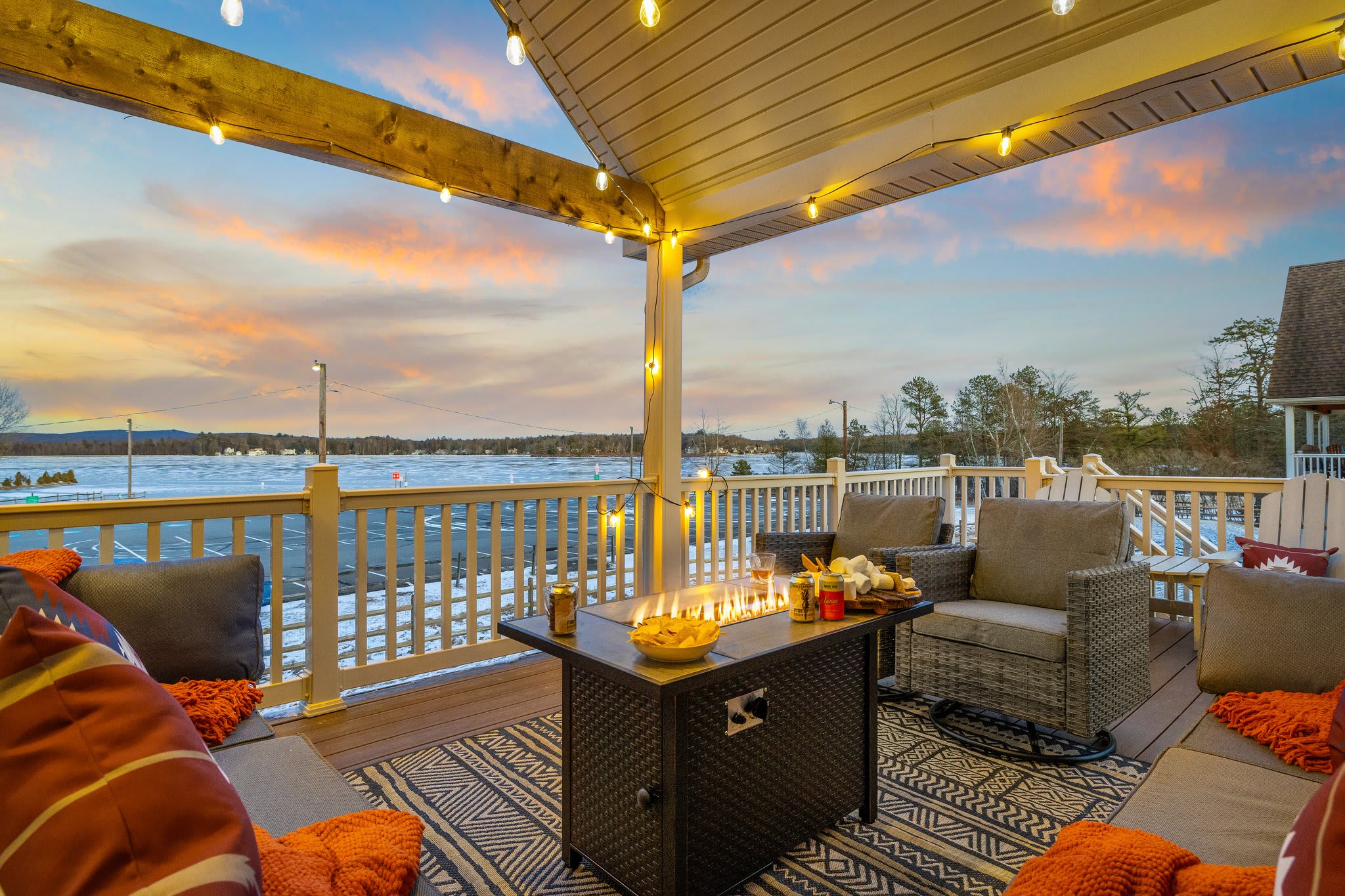 Lounge seating circled around a fire table, lake views all around, this is where evenings really come alive.