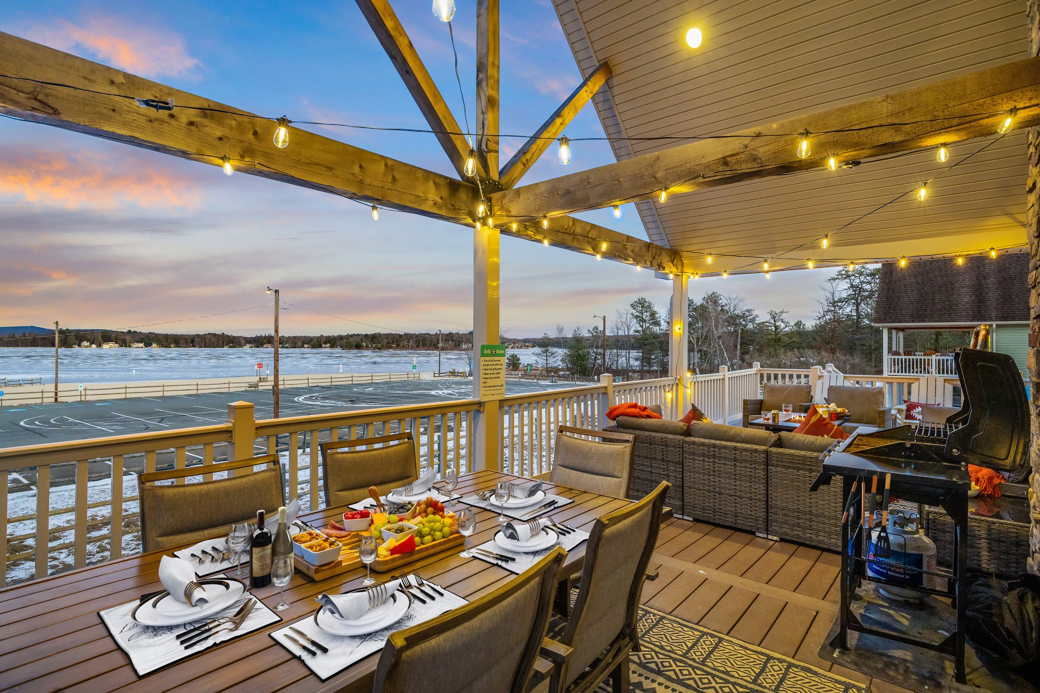 A full dining setup under a string-lit roof, with the lakefront as your backdrop. Every meal feels like a celebration.