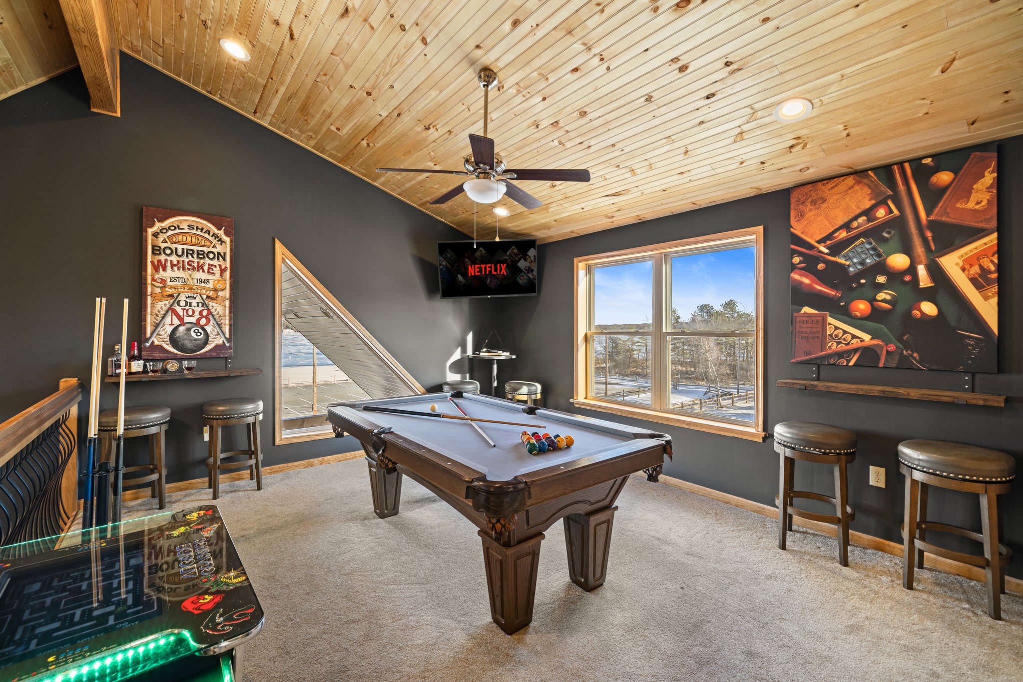 A sleek pool table, bold wall art, and neon-edged arcade games make this a hangout spot with serious vibes.