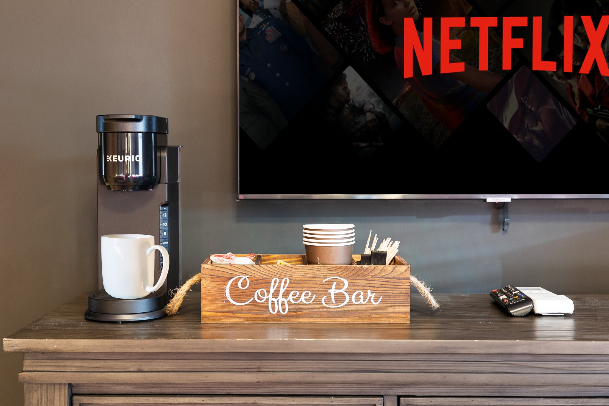 Compact and charming, this built-in coffee bar sits under a mounted Netflix-ready TV, perfect for laid-back mornings.