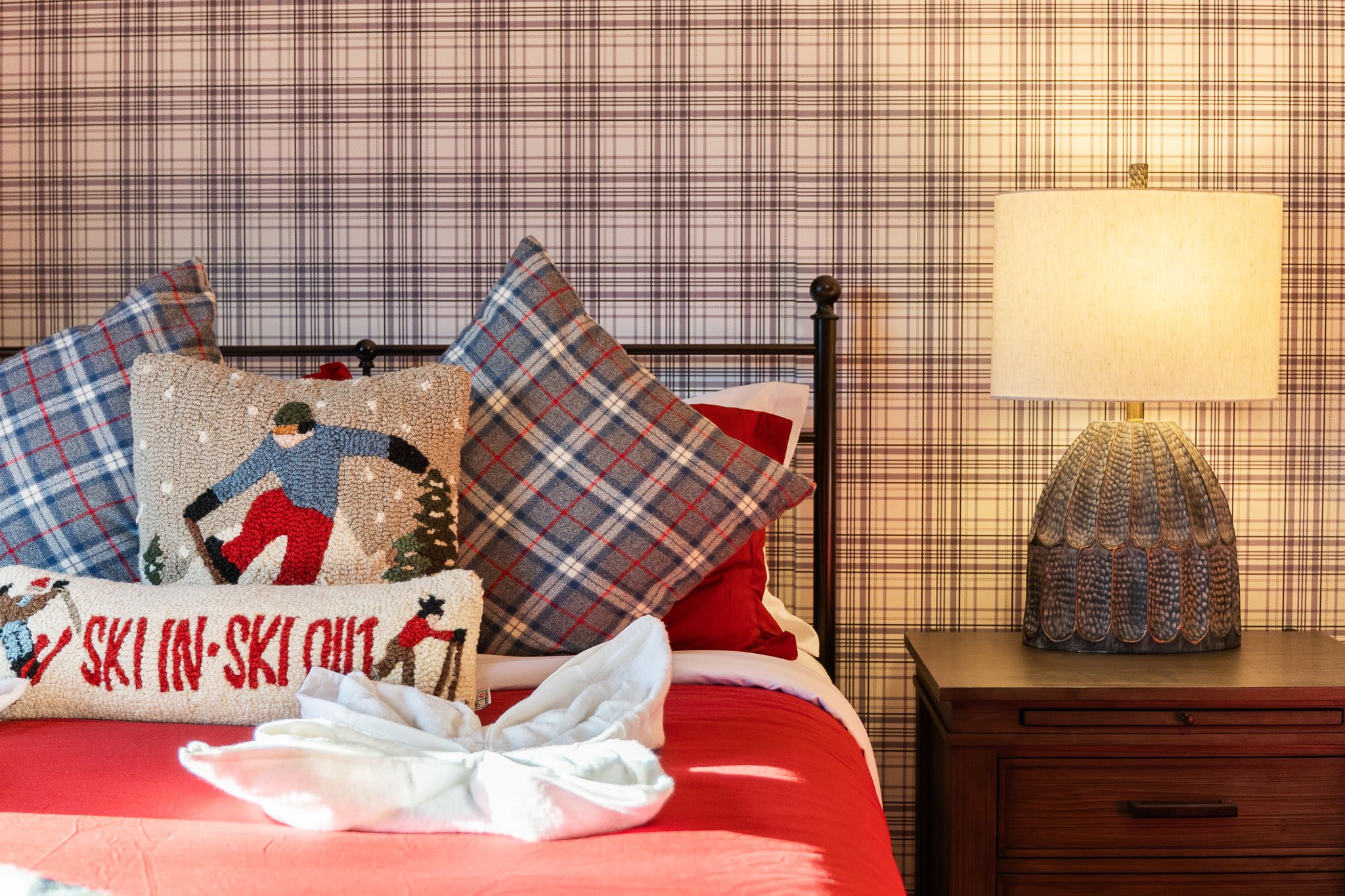 Close-up on soft textures, charming pillows, and warm light, a cozy bedtime vibe with personality.