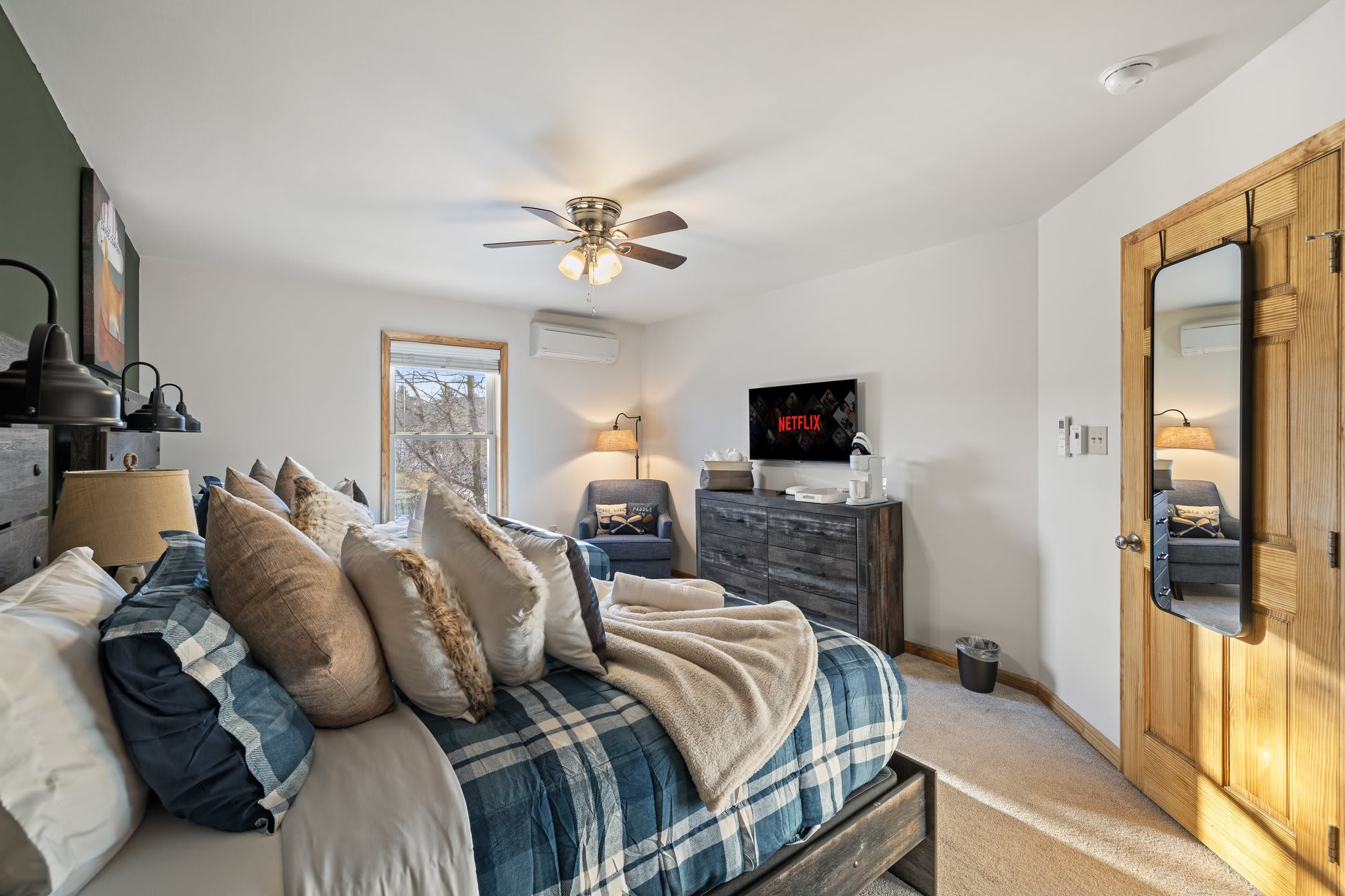 Stylish plaid comforter, and soft natural lighting, this room is ideal for snuggling up after a day outdoors.