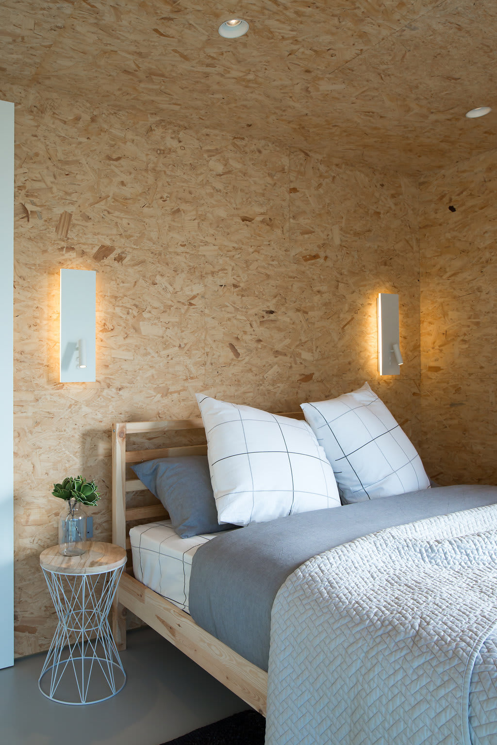 The master bedroom has a comfy king sized bed and Scandinavian style furniture.