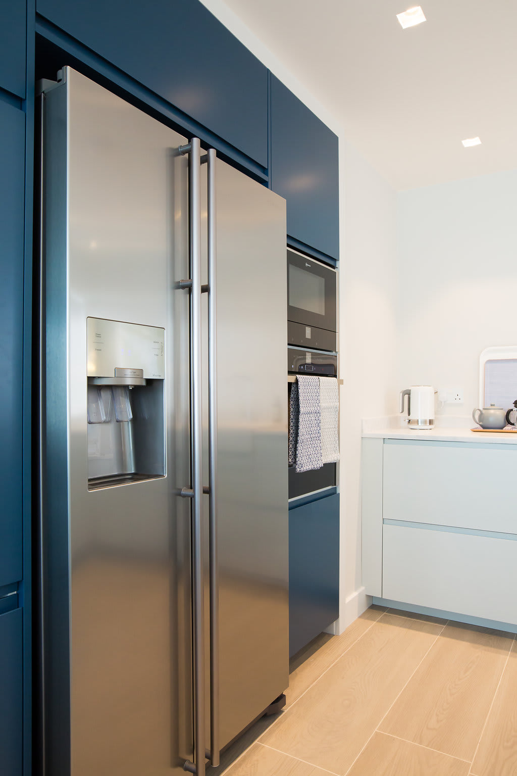 The kitchen features a large American style fridge freezer.