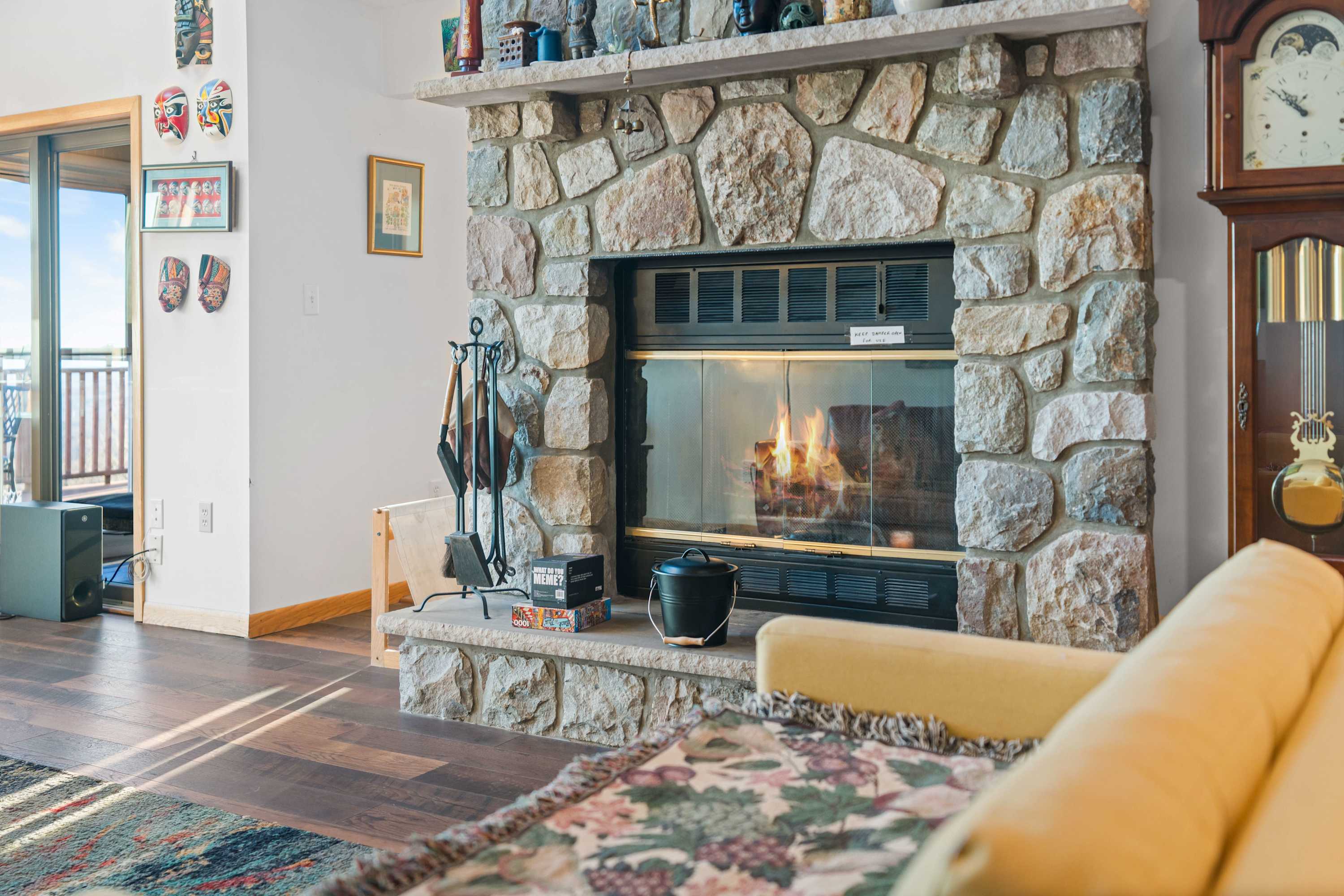 That stone fireplace adds such a cozy and rustic charm to the space! Perfect for a relaxing evening by the fire. 