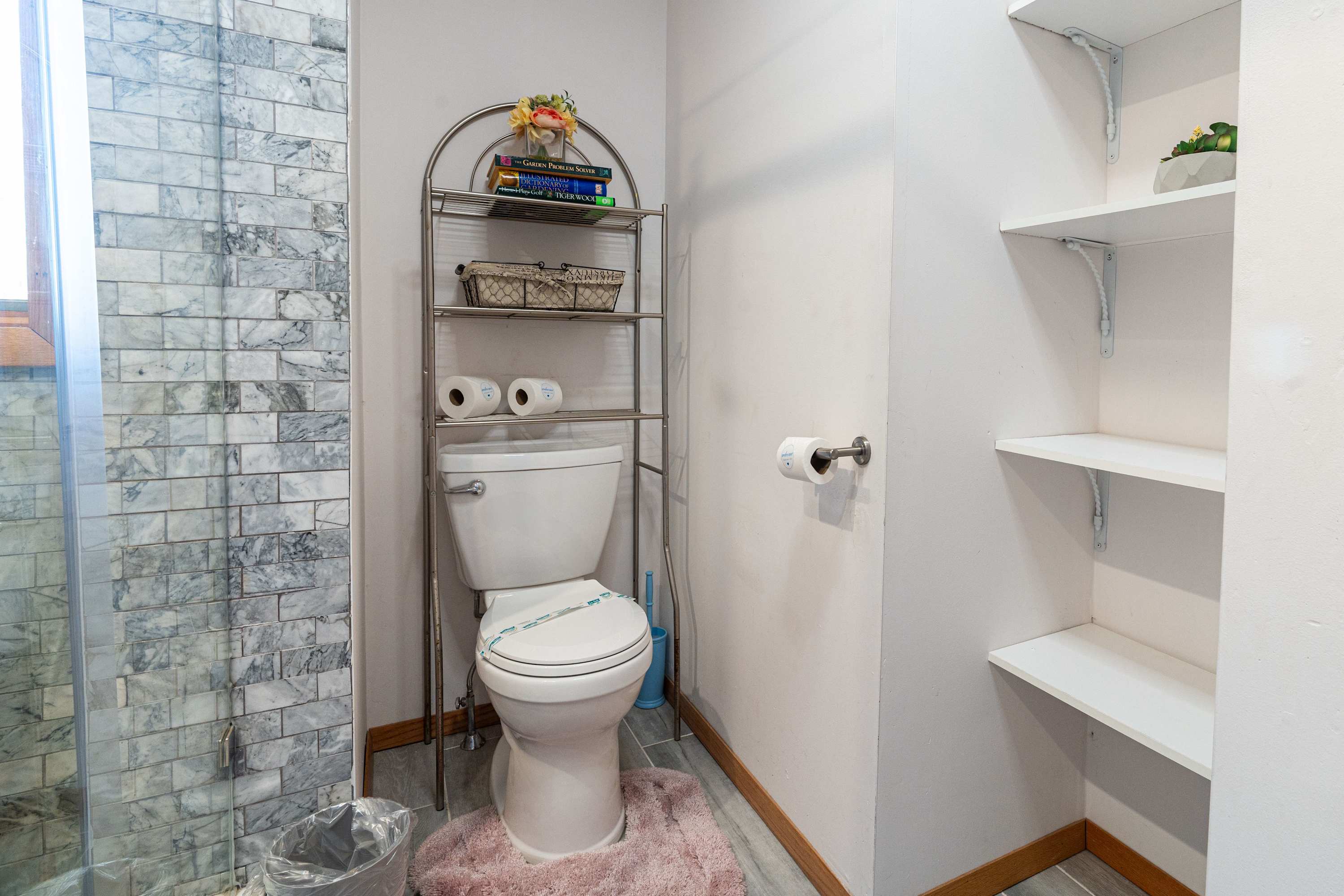 A well-appointed bathroom featuring modern tilework, ample storage, and essential amenities for a comfortable stay.