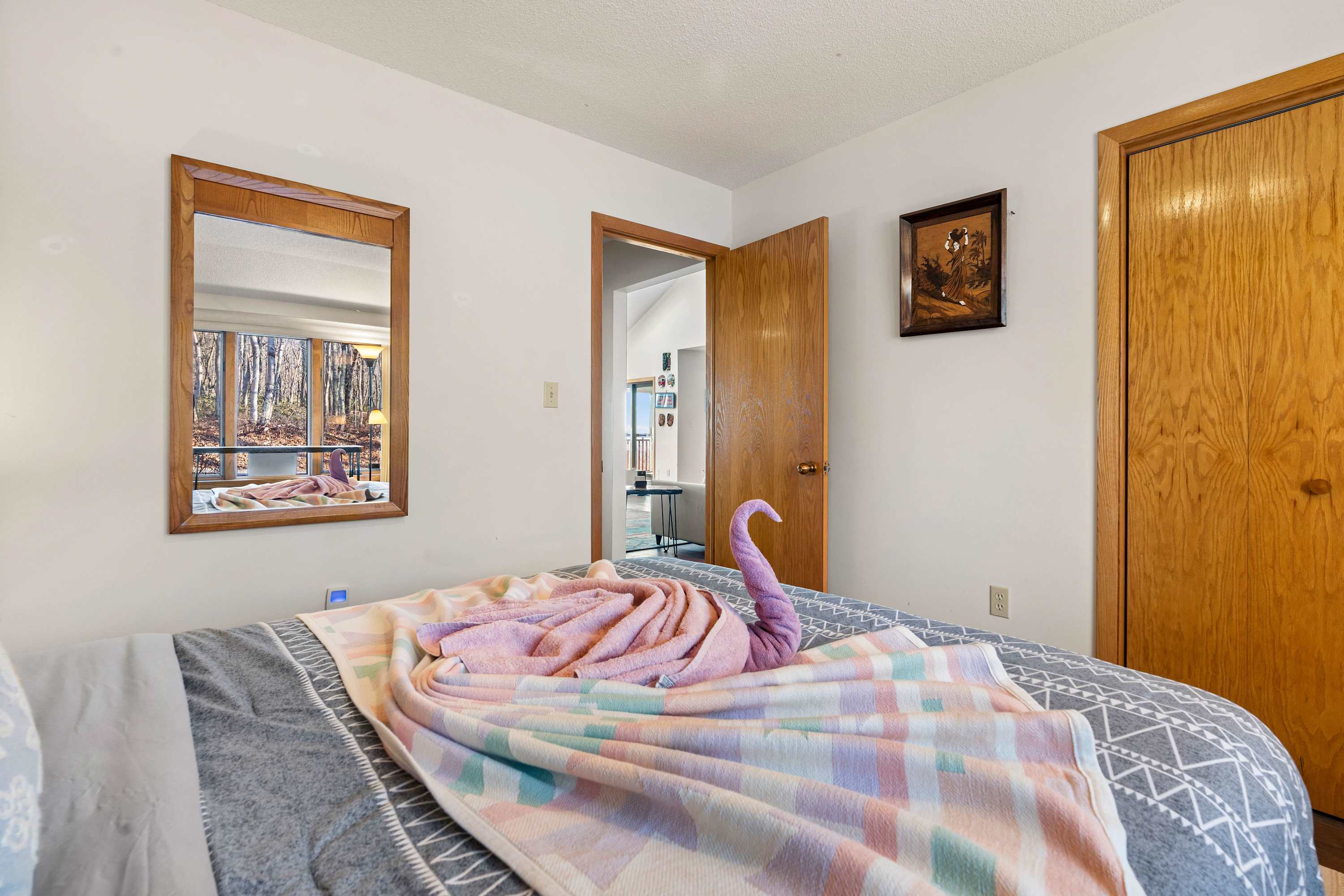 Warm wood details, plush bedding, and a whimsical towel fold, your home away from home.