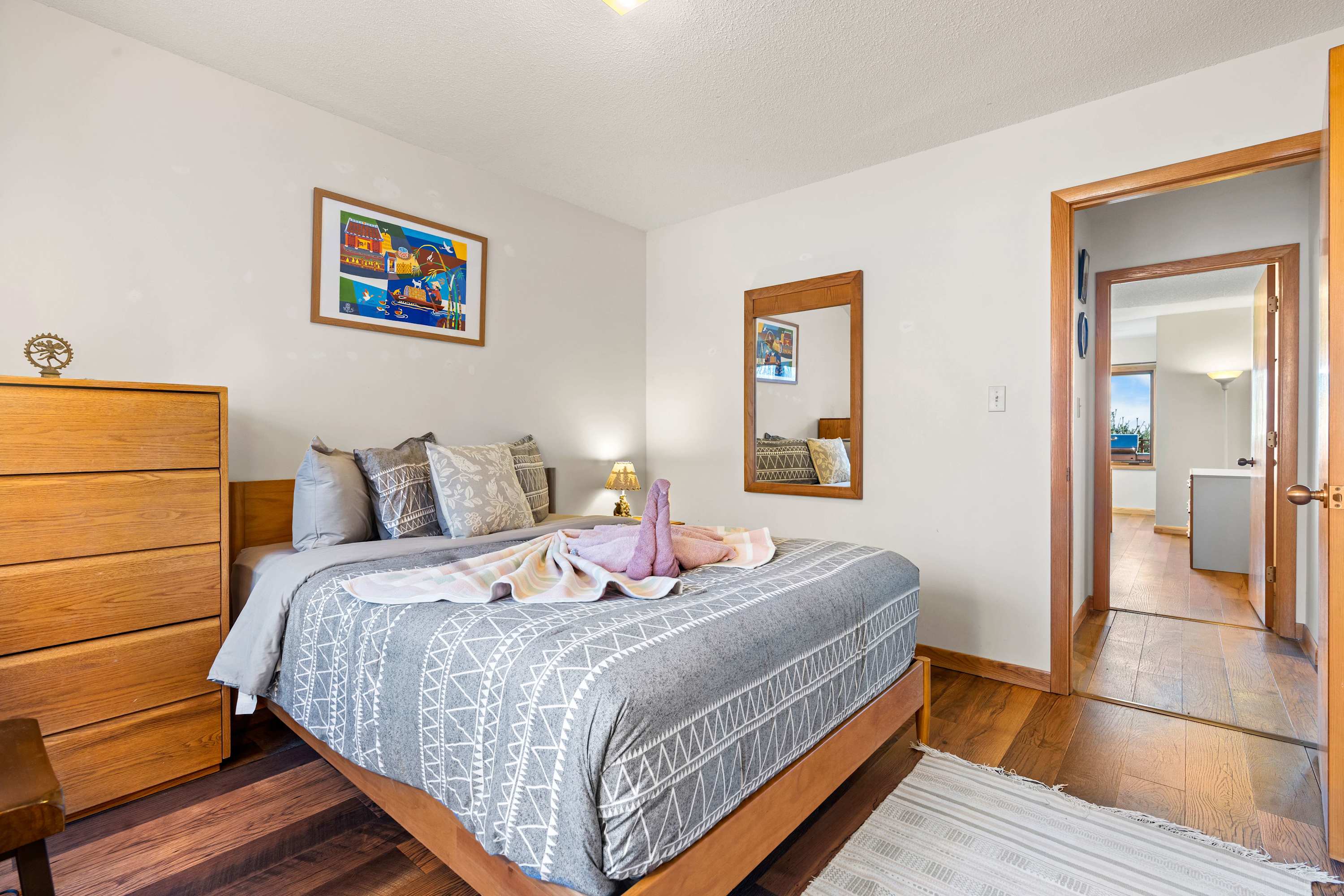 Wake up refreshed in a space that blends modern comfort with warm wooden finishes.