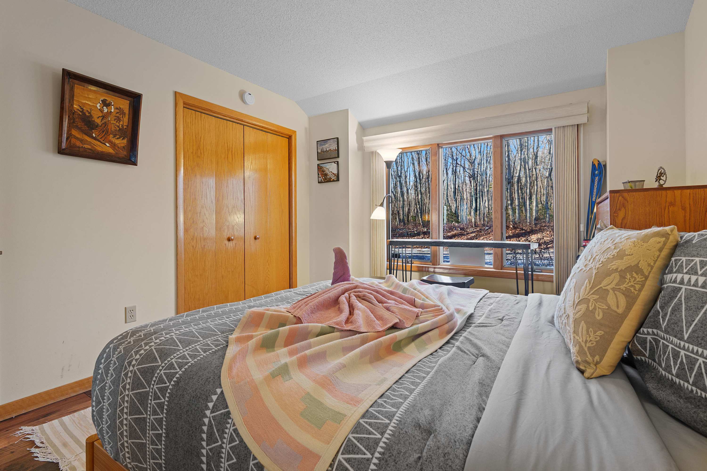 A serene space with soft linens, natural light, and ample closet storage.