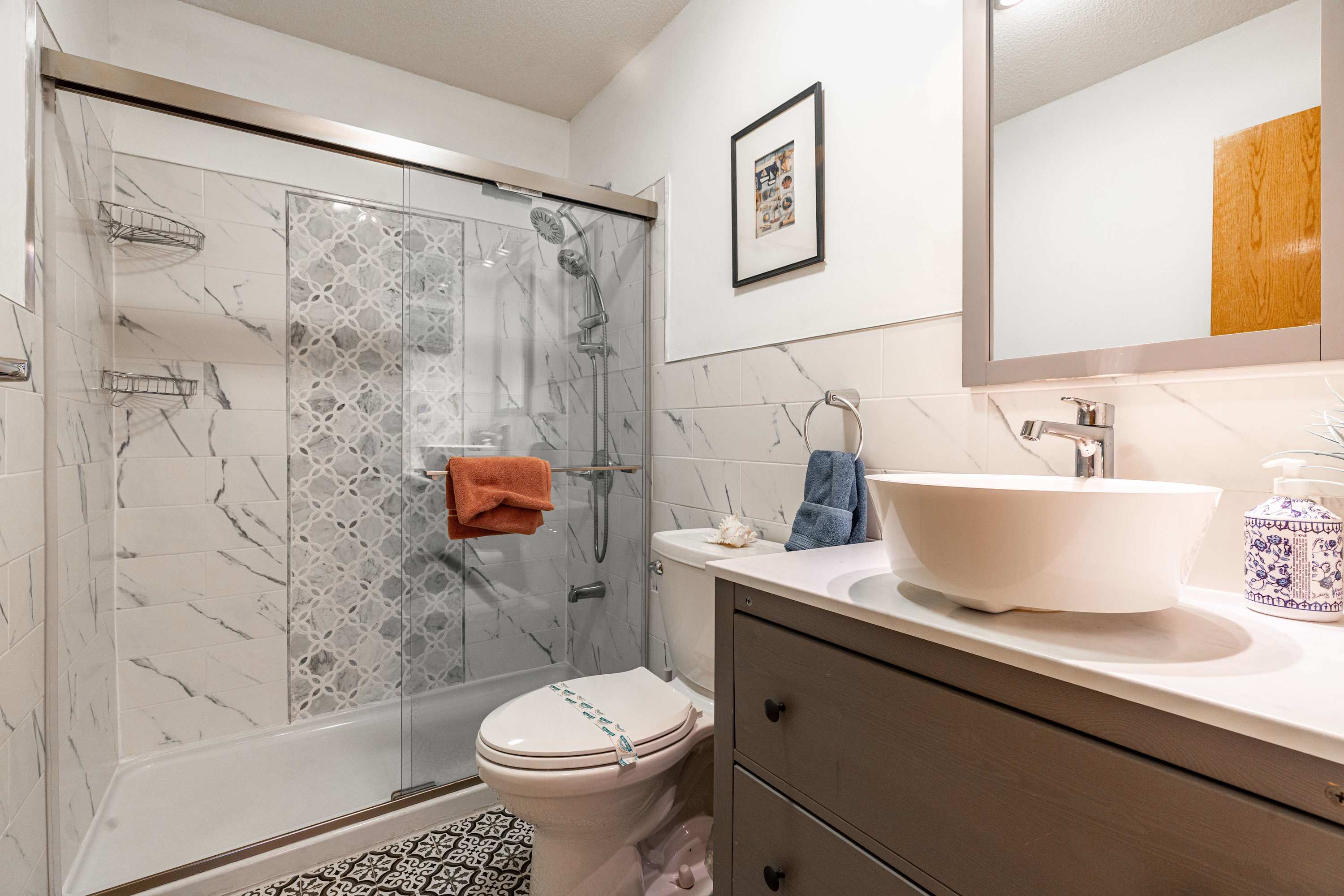 Elevate your stay with a sleek vanity, spacious shower, and soothing décor.