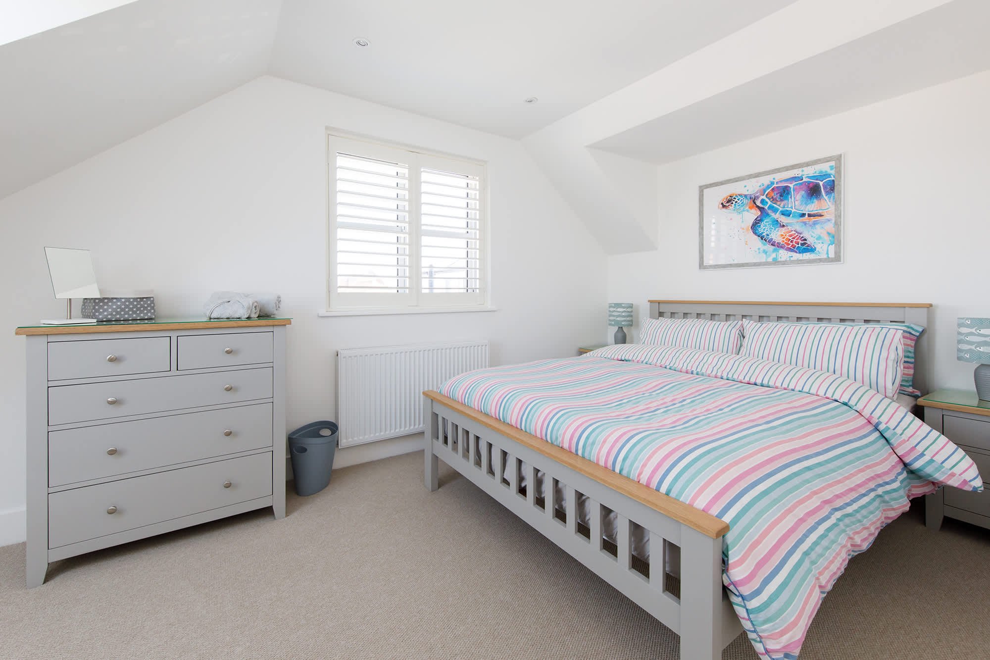 A chest of drawers and bedside table are provided for your personal belongings.