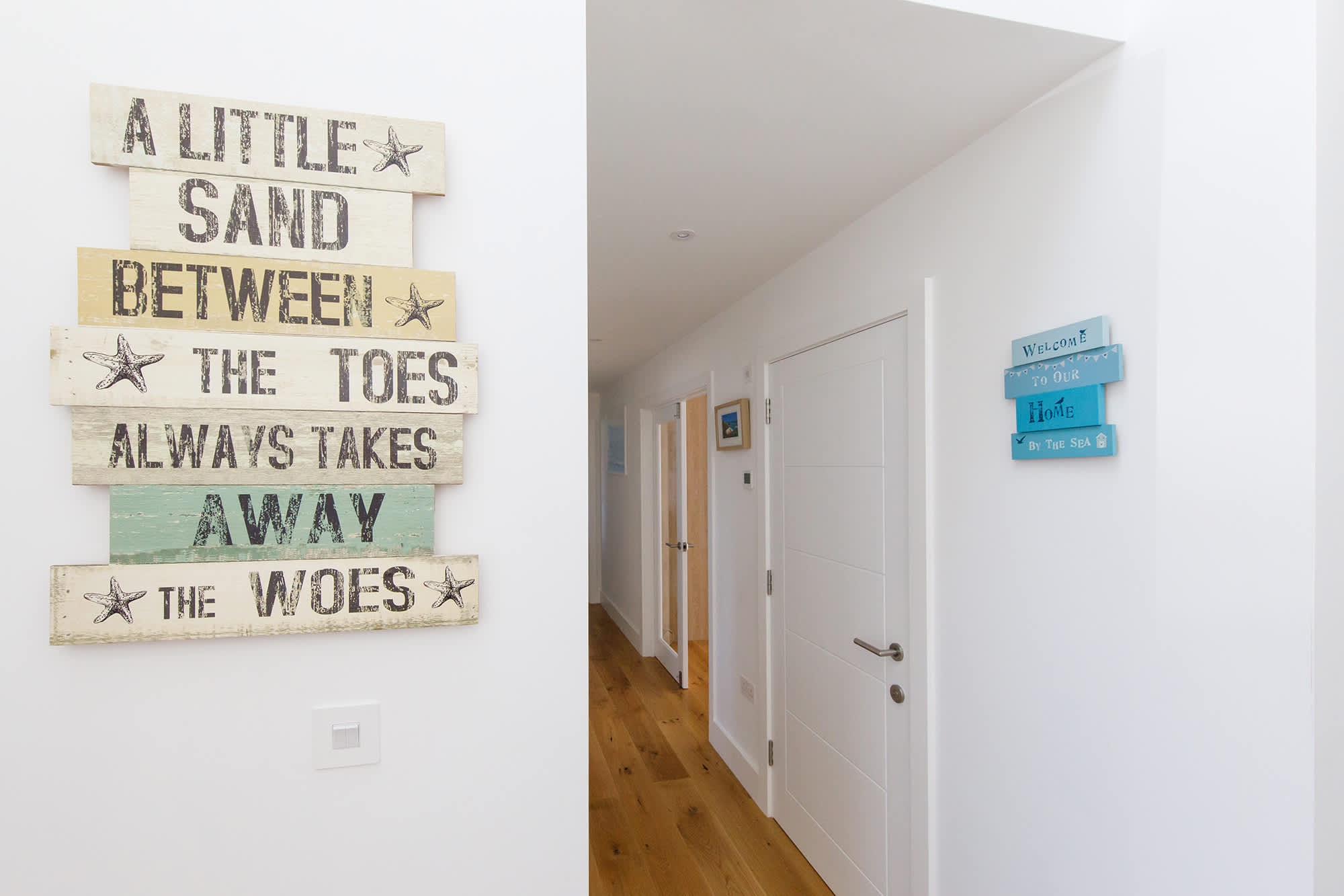 The first-floor hallway connects to two bedrooms as well as the living areas.