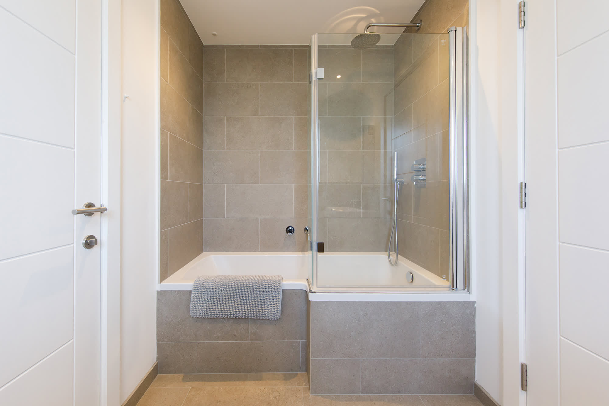 Unwind in the Jack & Jill bathroom with a unique l-shaped bathtub and the overhead shower