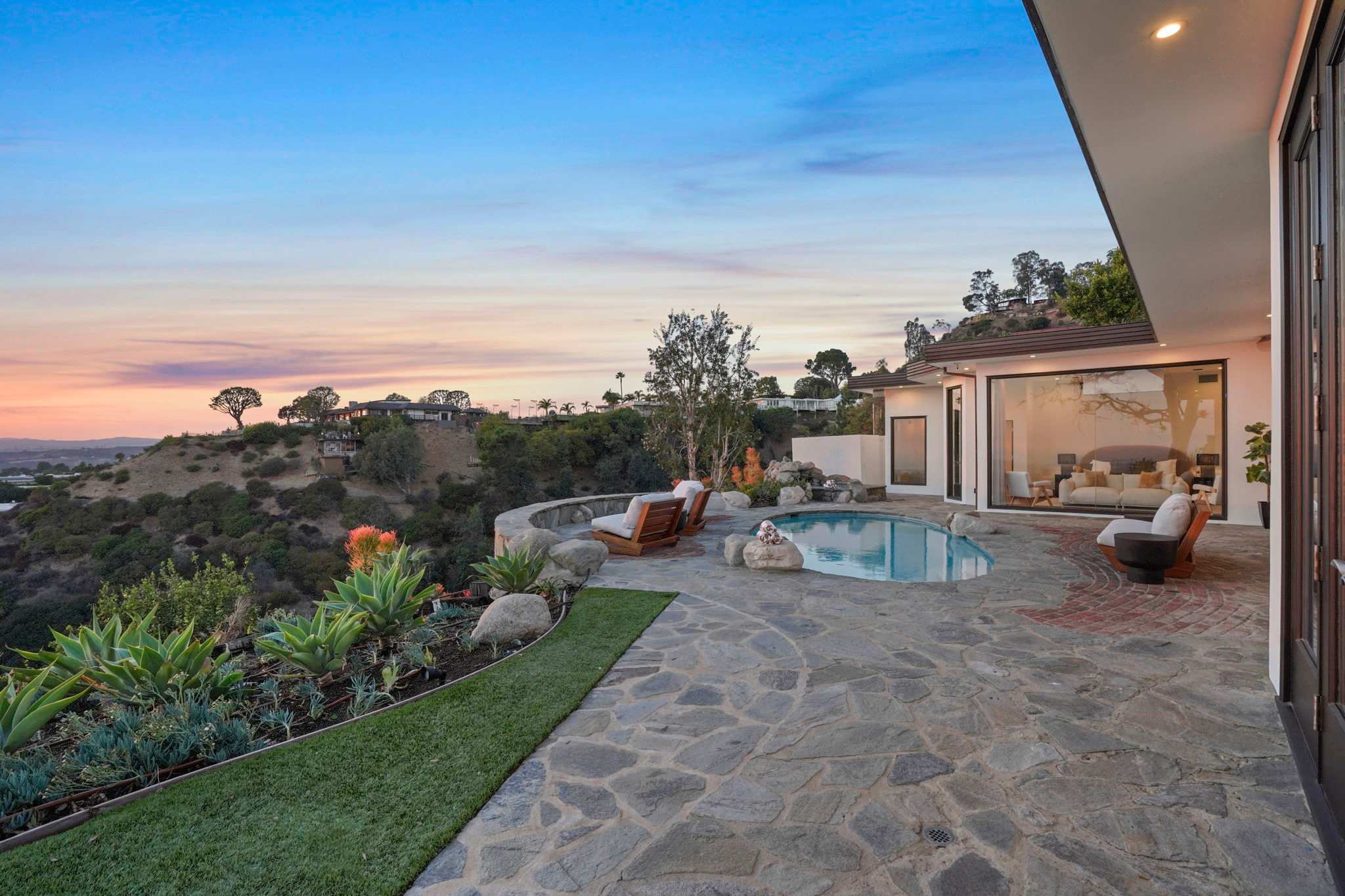 Bask in the glow of the horizon from the expansive stone patio.