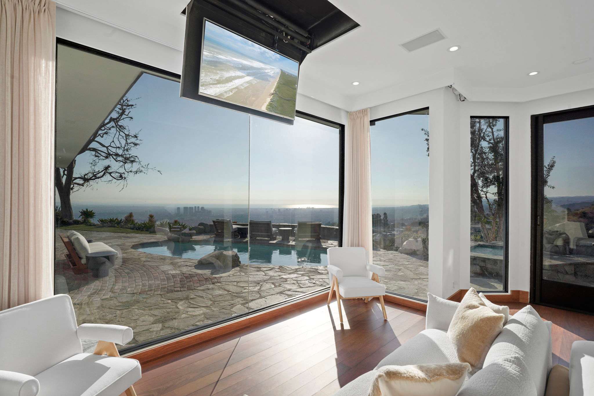 Panoramic glass walls frame the breathtaking skyline and ocean vistas.