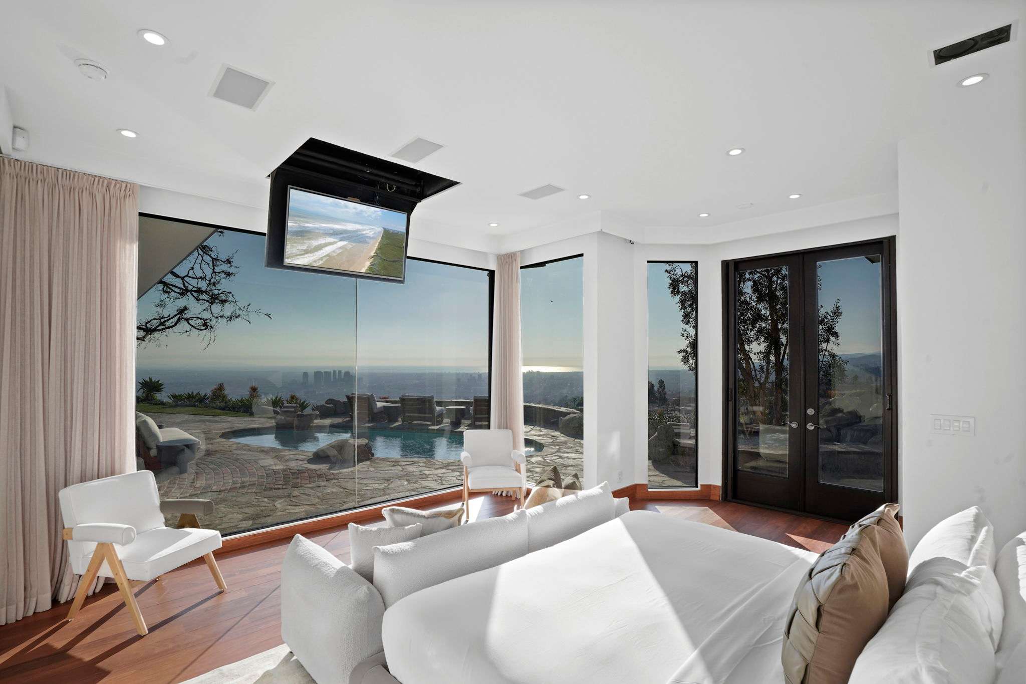 A ceiling-mounted television offers effortless entertainment.