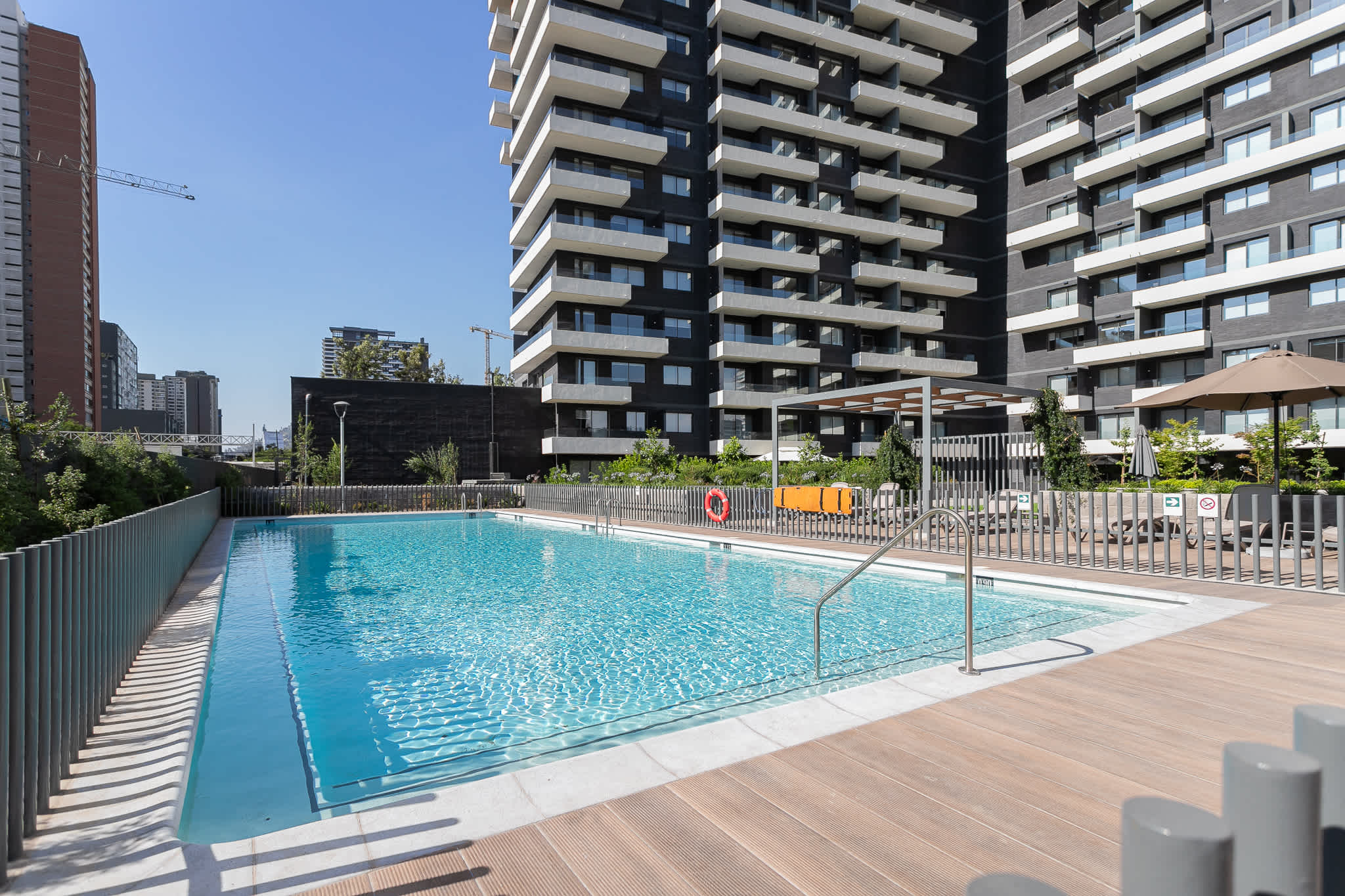 Relax by the sparkling pool with cityscape views, perfect for a refreshing dip or sunbathing.